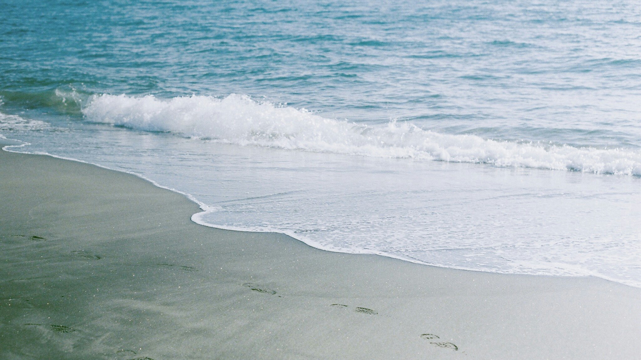 sandy beach with waves rolling in