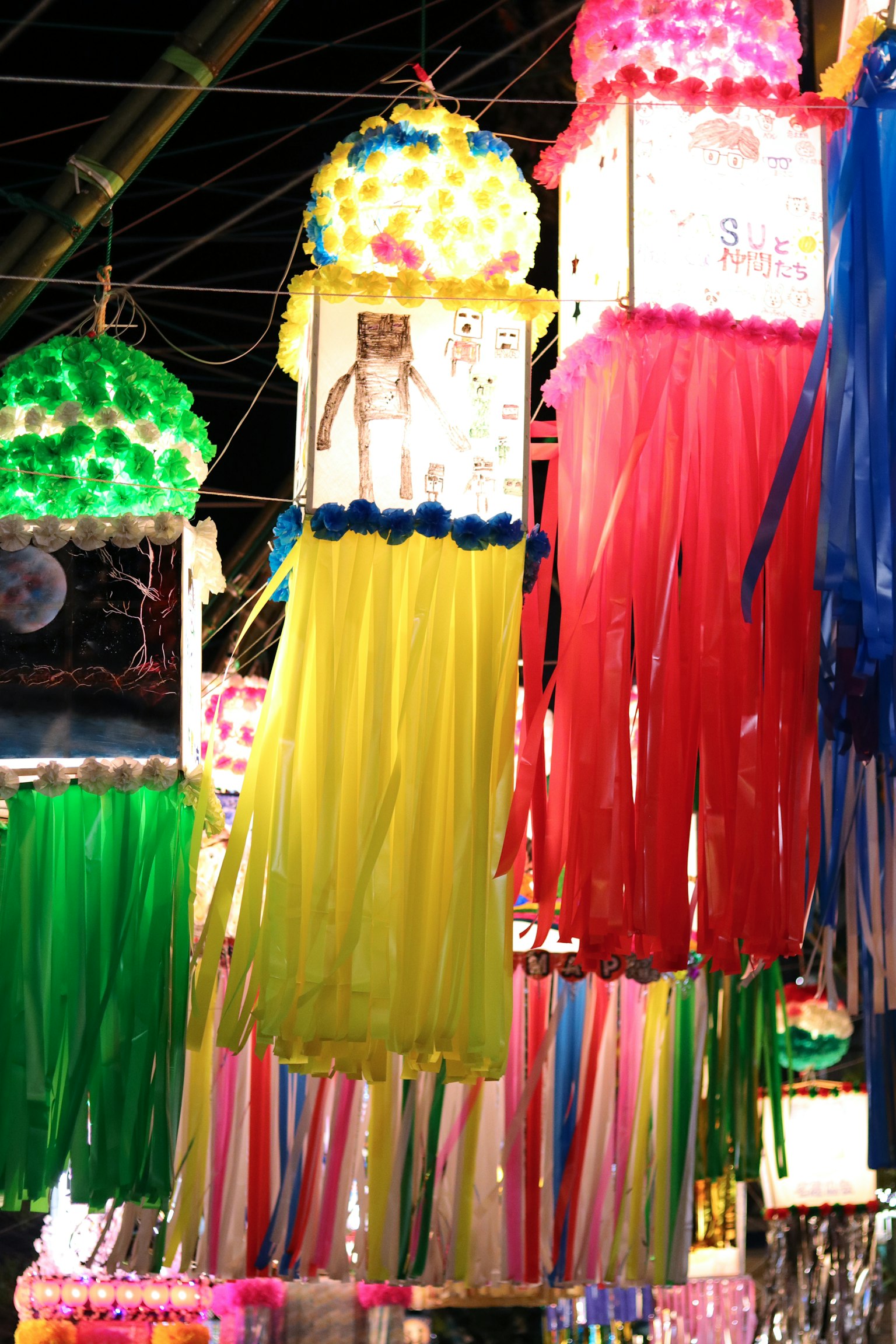 Colorful lanterns hanging in a night market scene