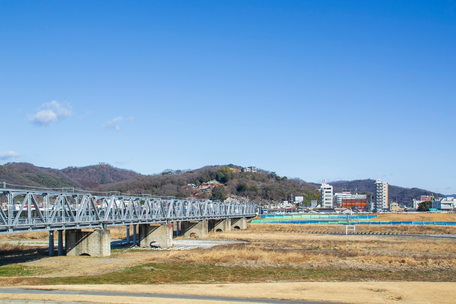 Landscape of a river and bridge under a blue sky