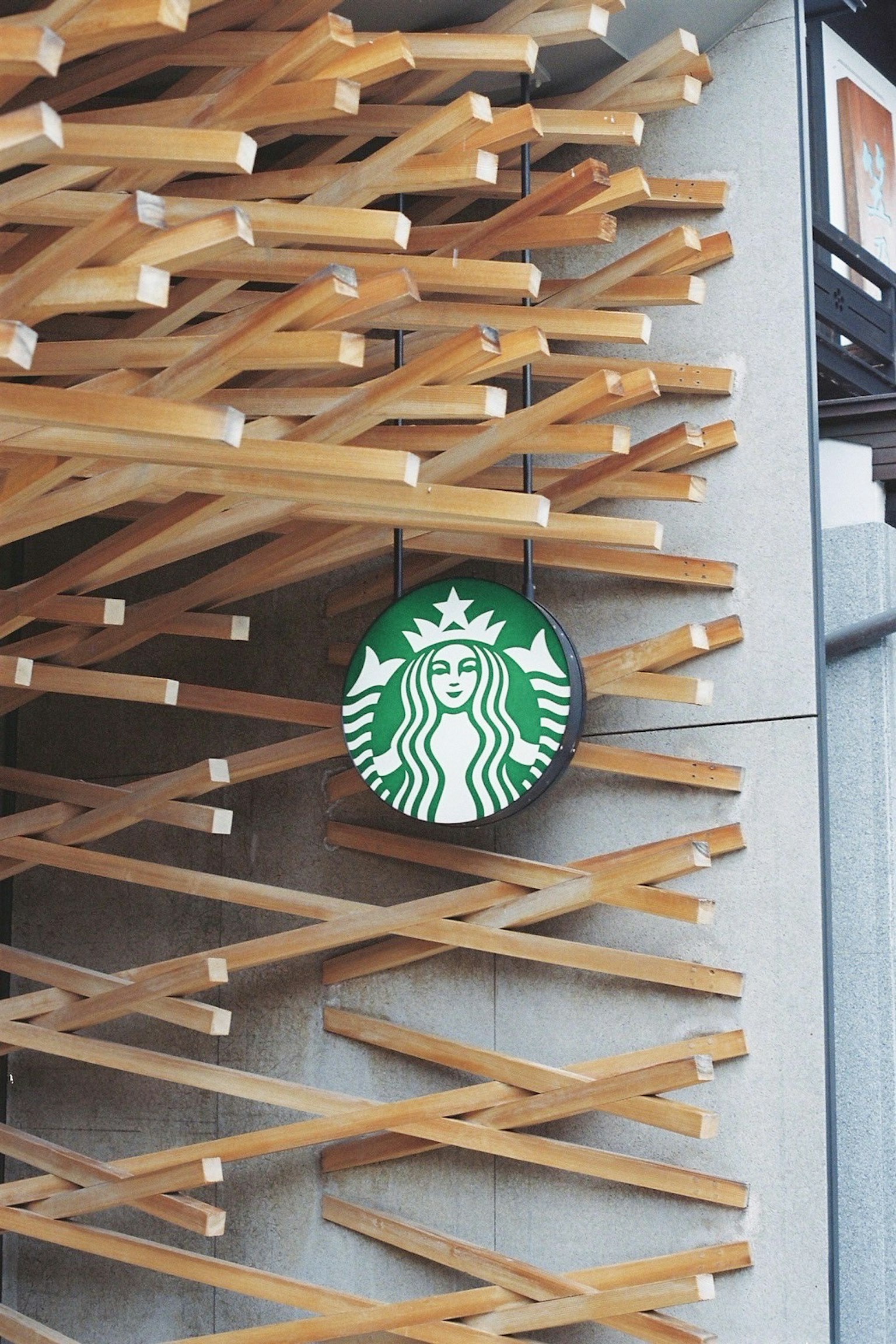 Logo Starbucks suspendu sur un mur en bois avec un design unique