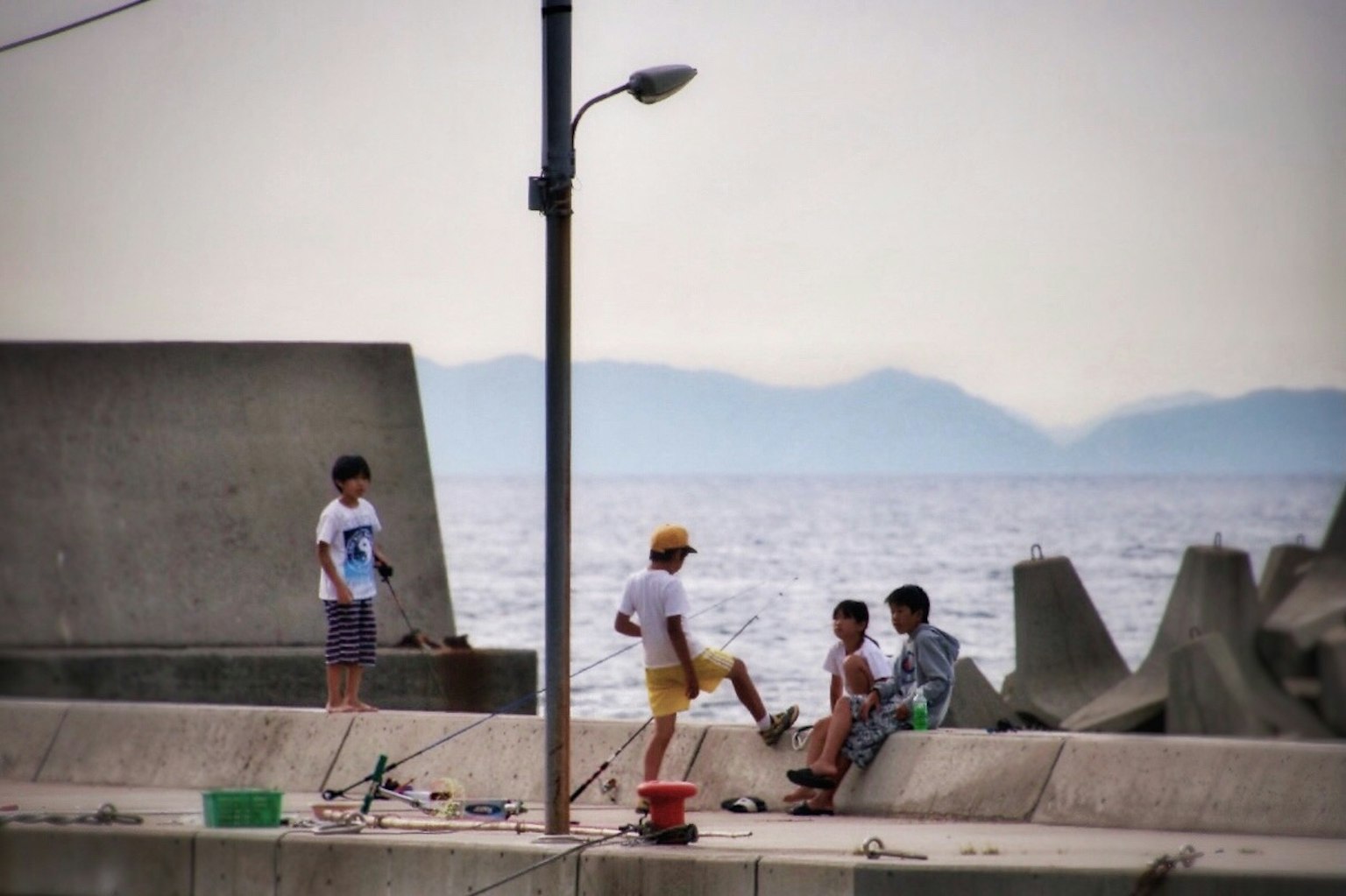 海邊玩耍的孩子們和防波堤的風景
