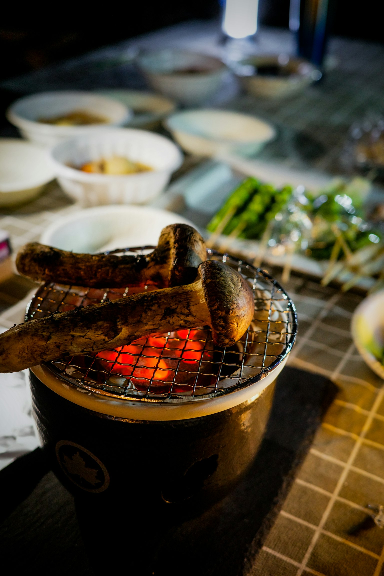 夜景，炭火烧烤架上正在烹饪的肉块