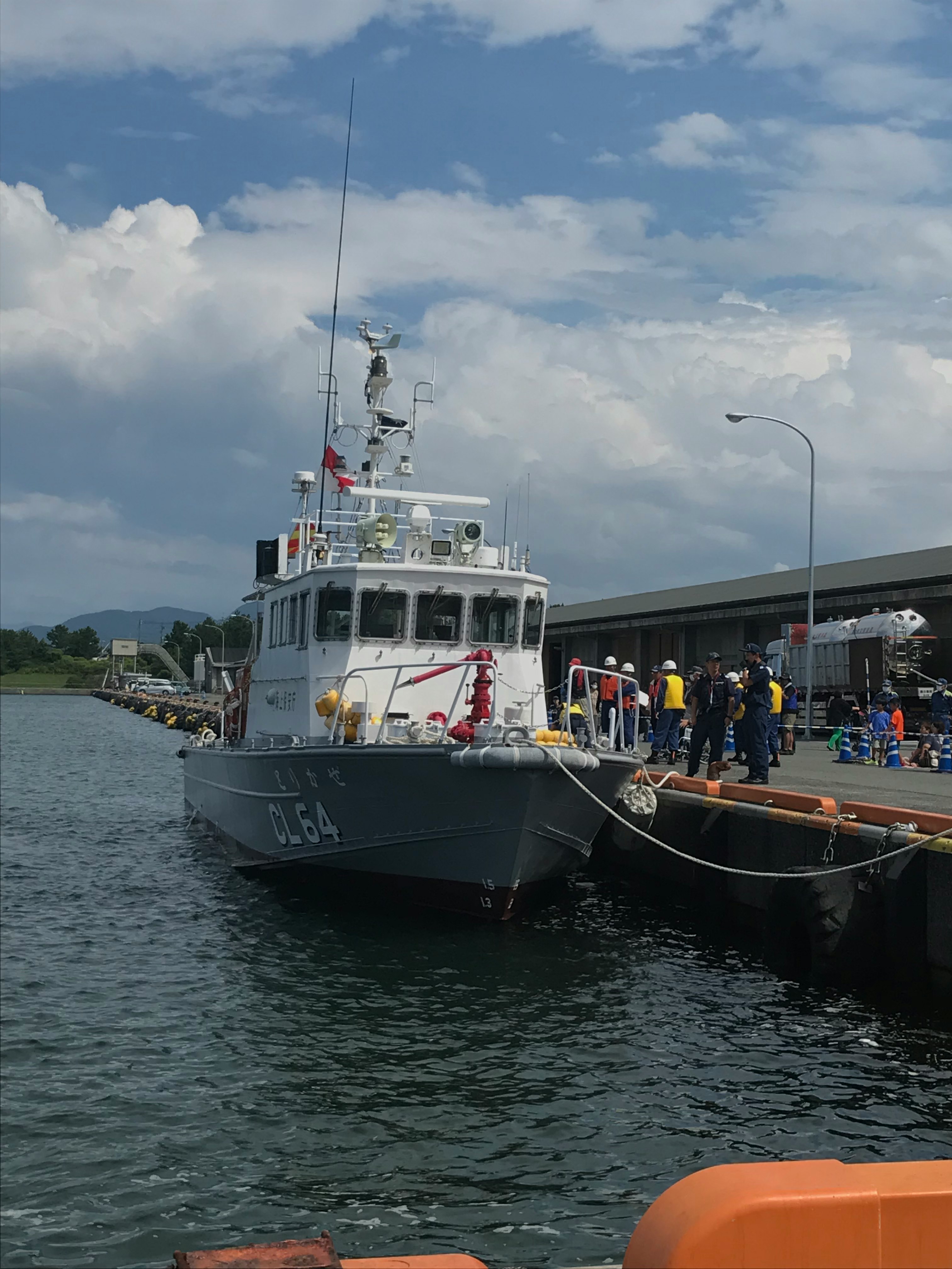 harbor vessel docked with crew on deck