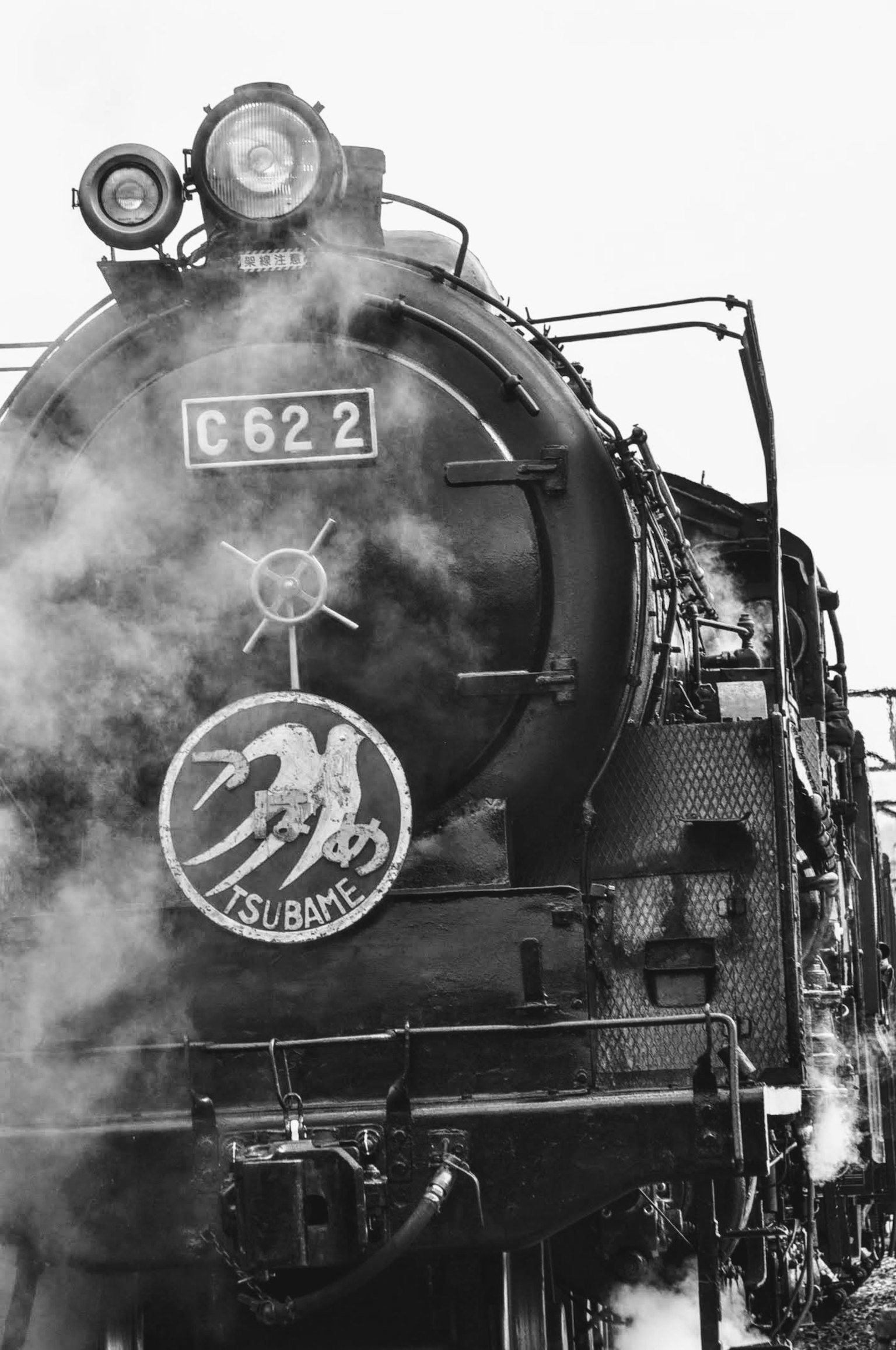 Front view of steam locomotive C622 with smoke billowing