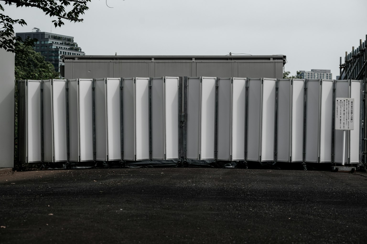 Exterior view of a building with white panels arranged in a row