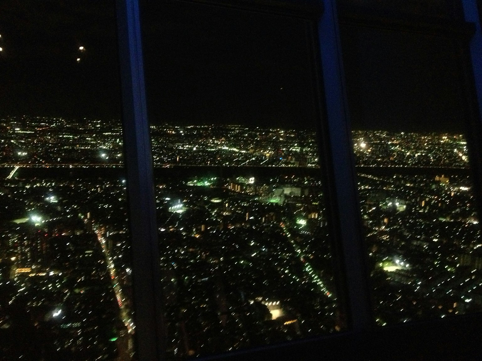 Panoramic view of a city at night with bright lights scattered