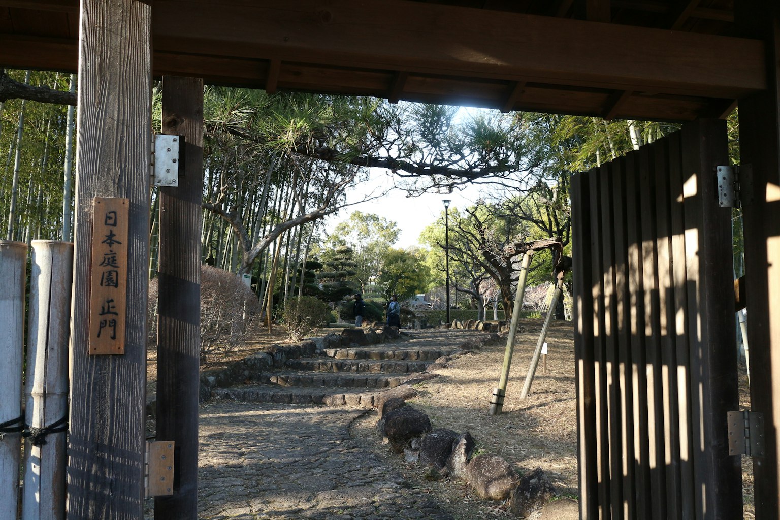 Vista di un giardino sereno attraverso un cancello di legno