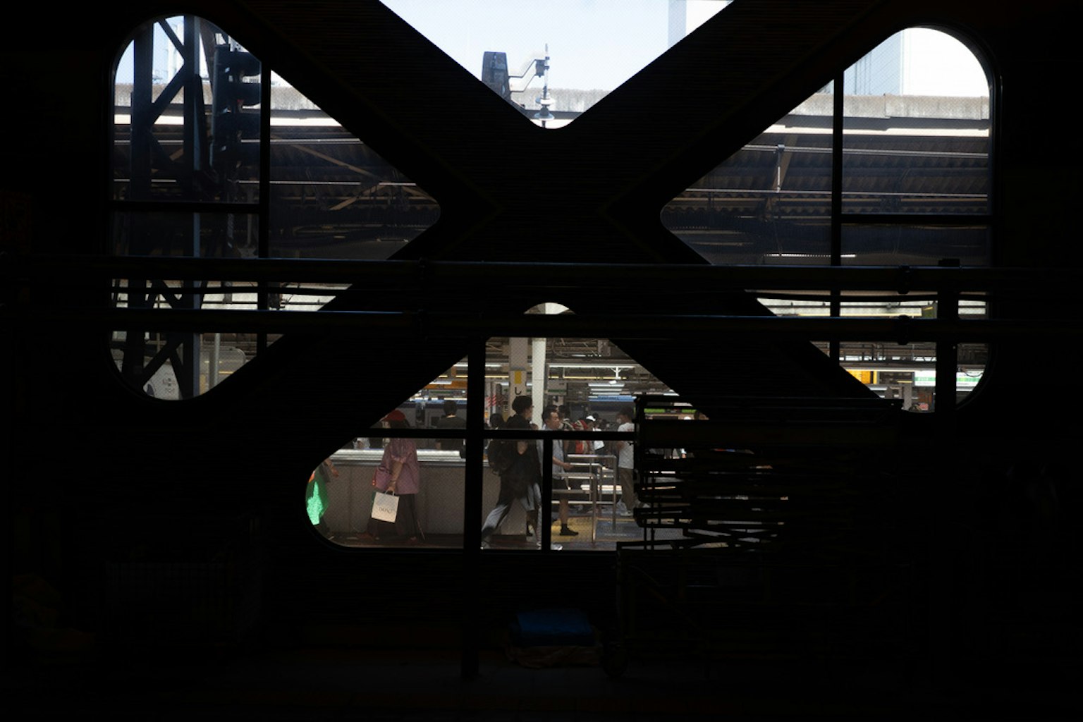 View of a factory interior and workspace through an X-shaped frame