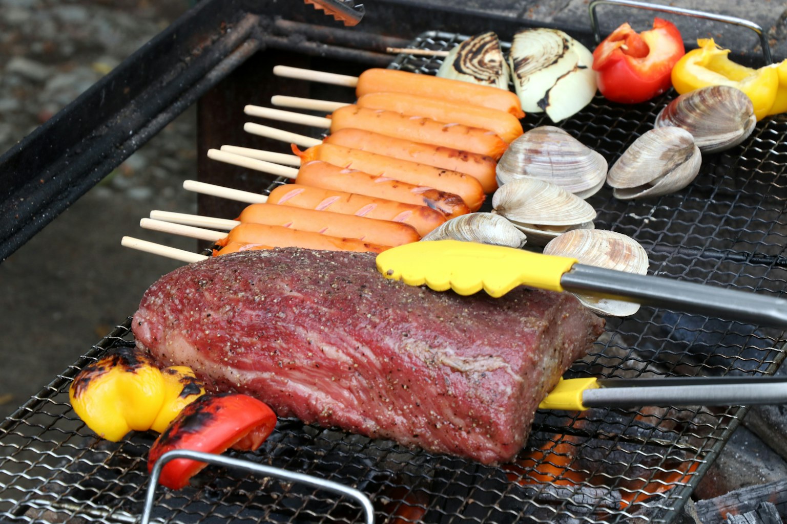 Barbecue with grilled meat and vegetables on a grill
