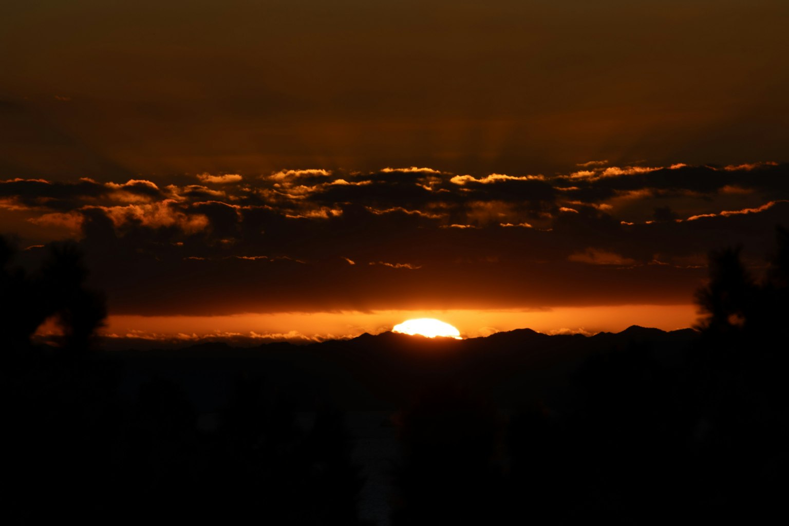 Beautiful sunset landscape with orange sky and silhouetted clouds