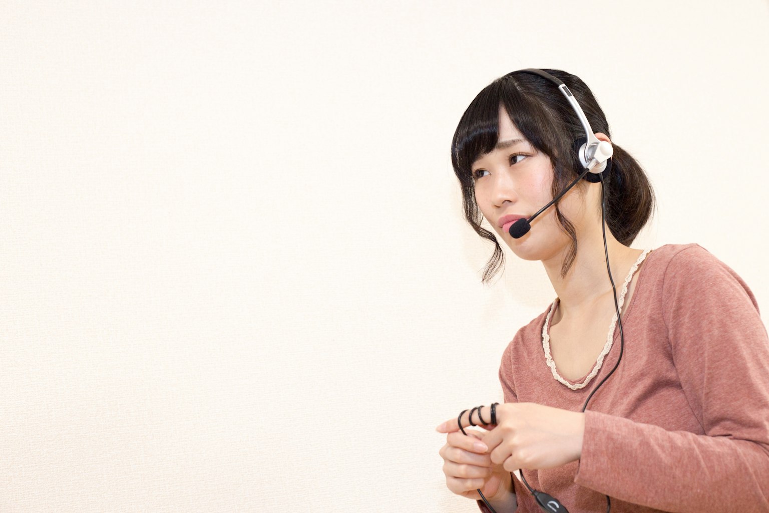 A woman wearing a headset speaking into a microphone