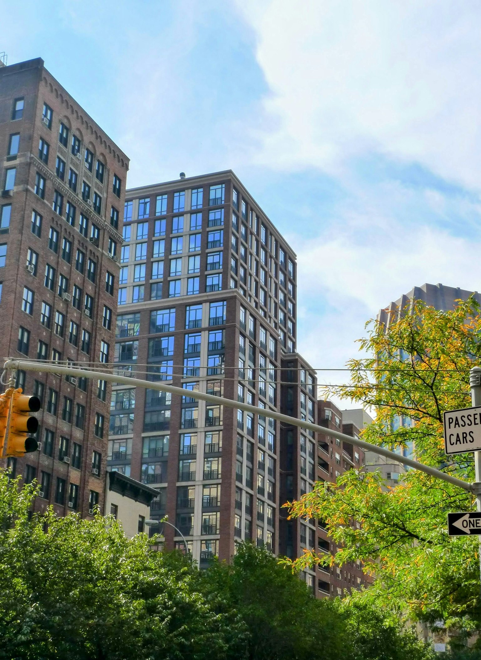 Urban skyline featuring modern and classic buildings under a blue sky