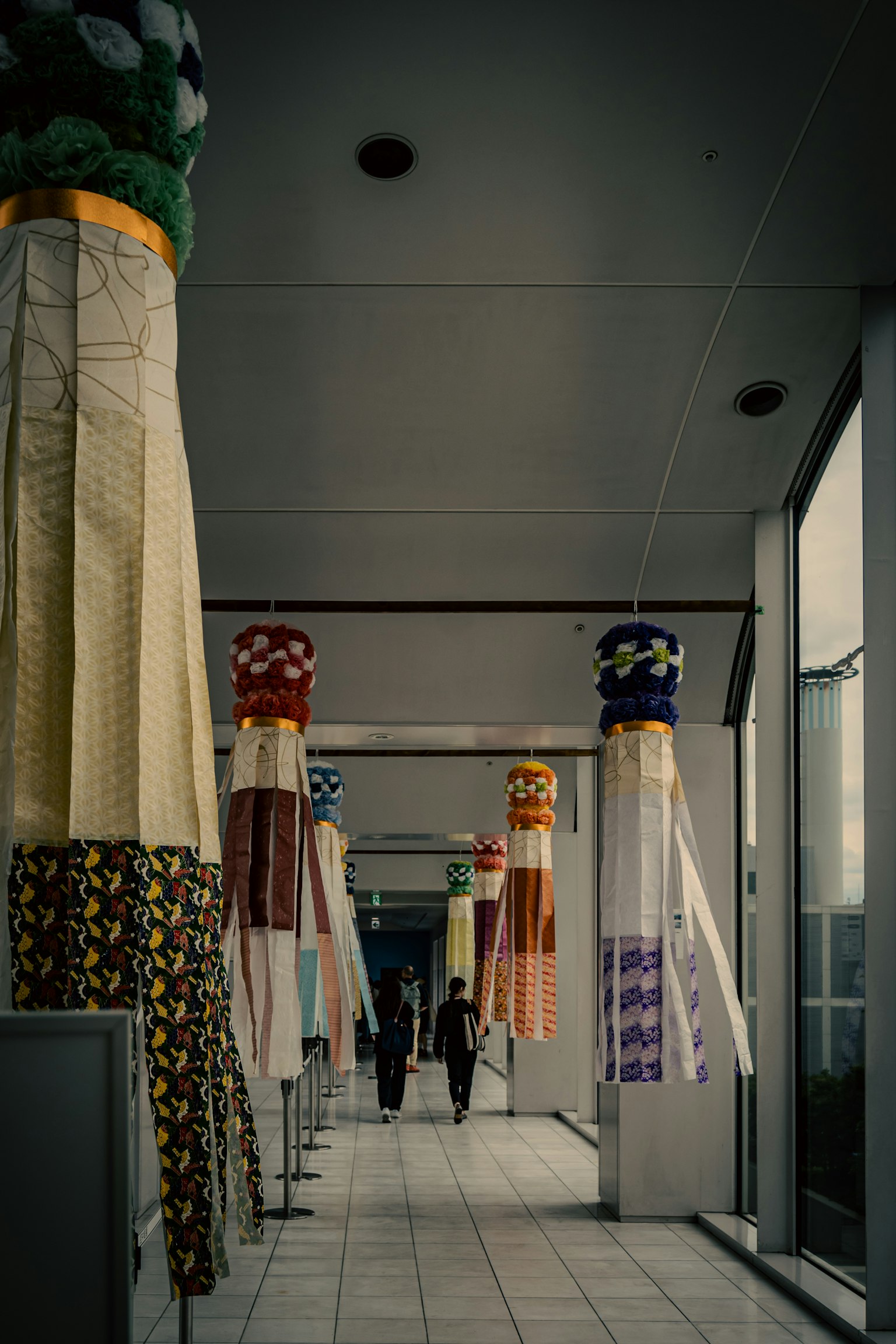 A hallway featuring colorful decorated columns with various patterns