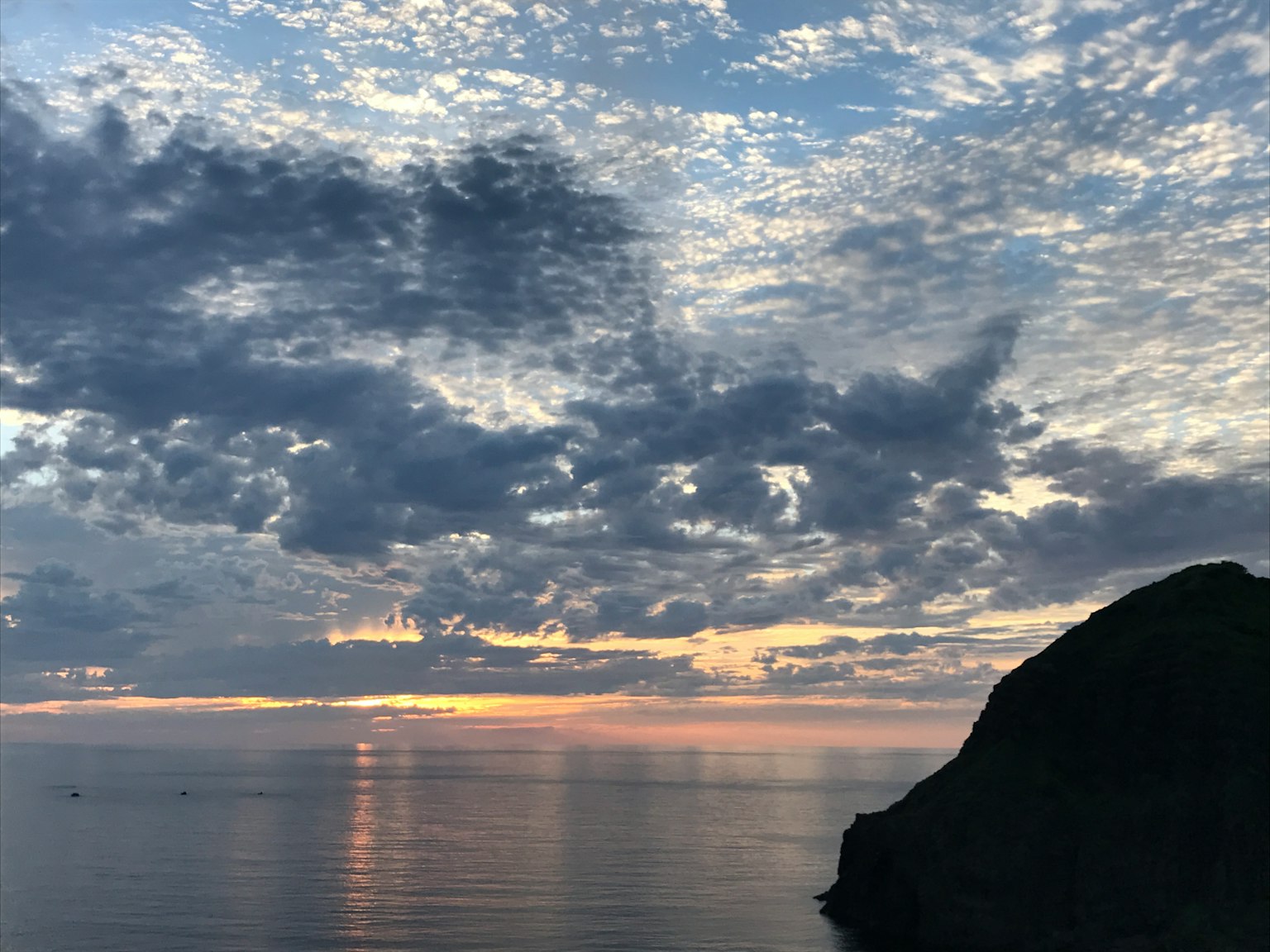 Beautiful seascape at sunset with clouds and calm water