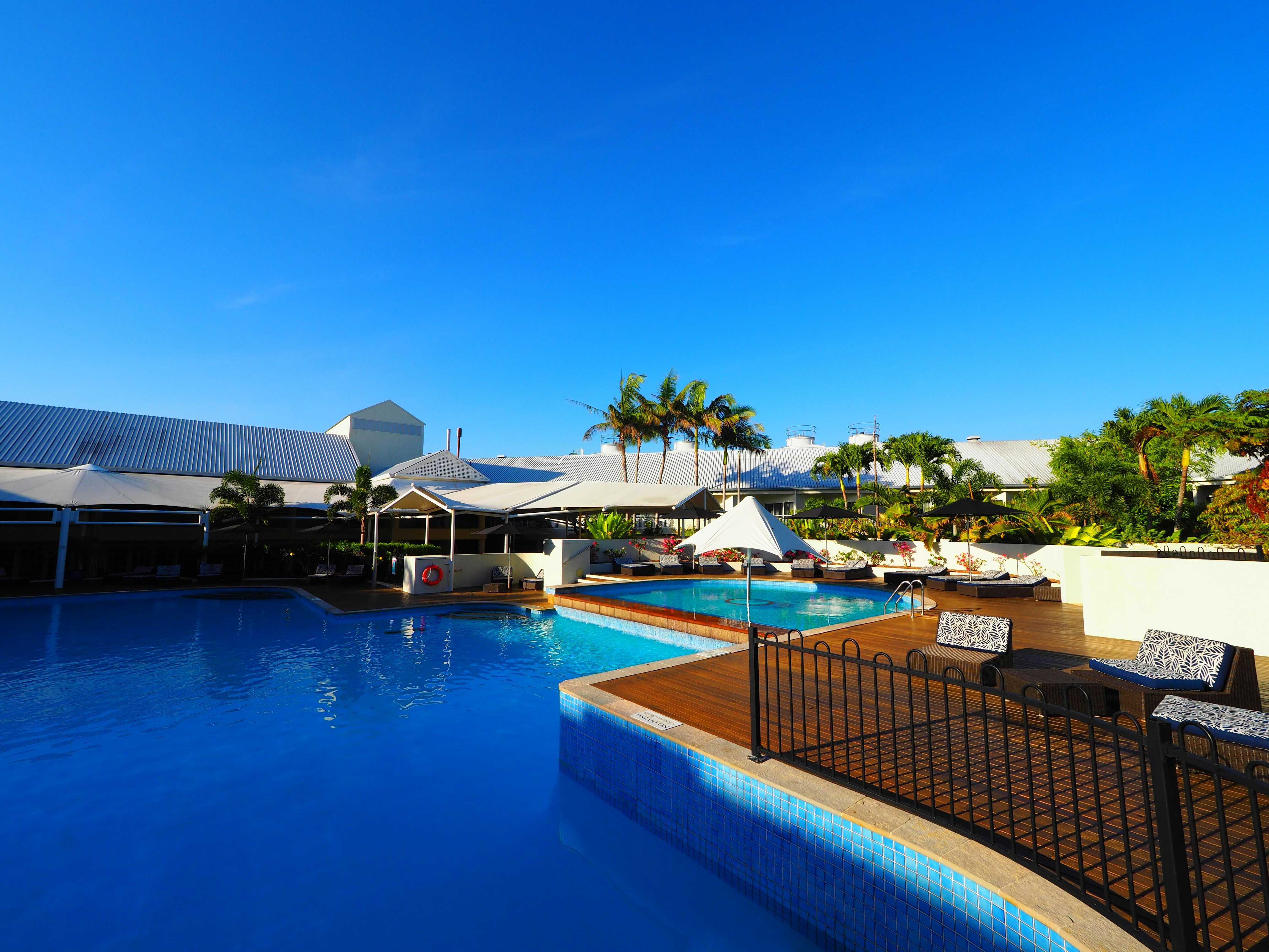 outdoor resort pool under a clear blue sky