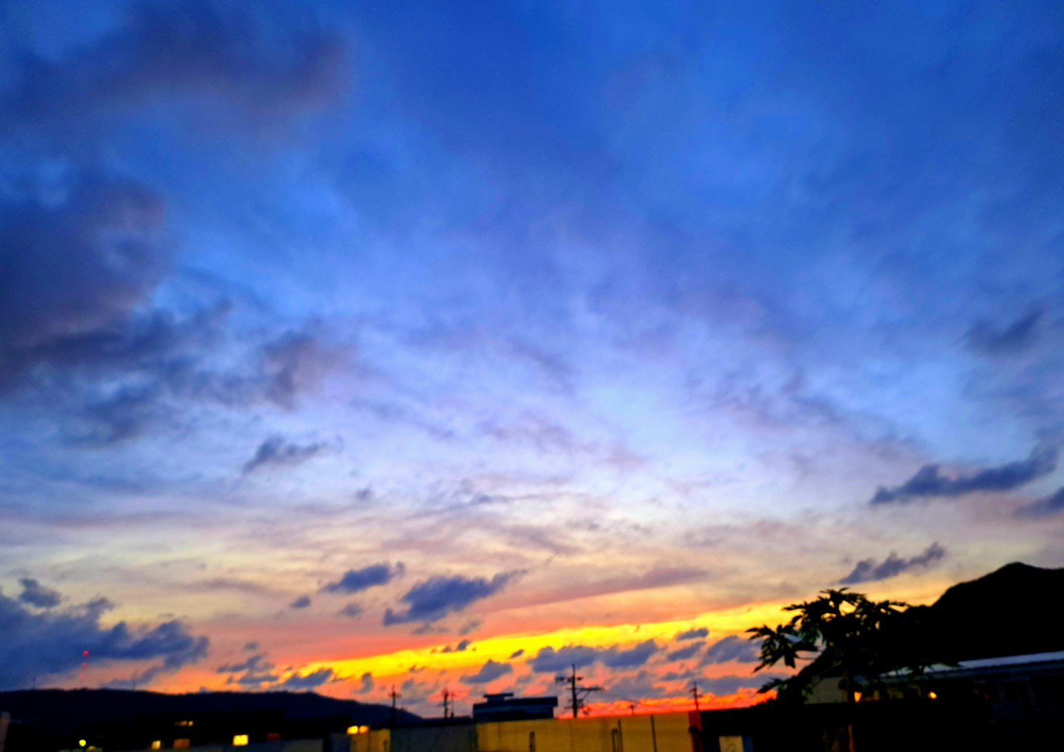 Matahari terbenam yang menakjubkan dengan langit biru cerah dan awan oranye