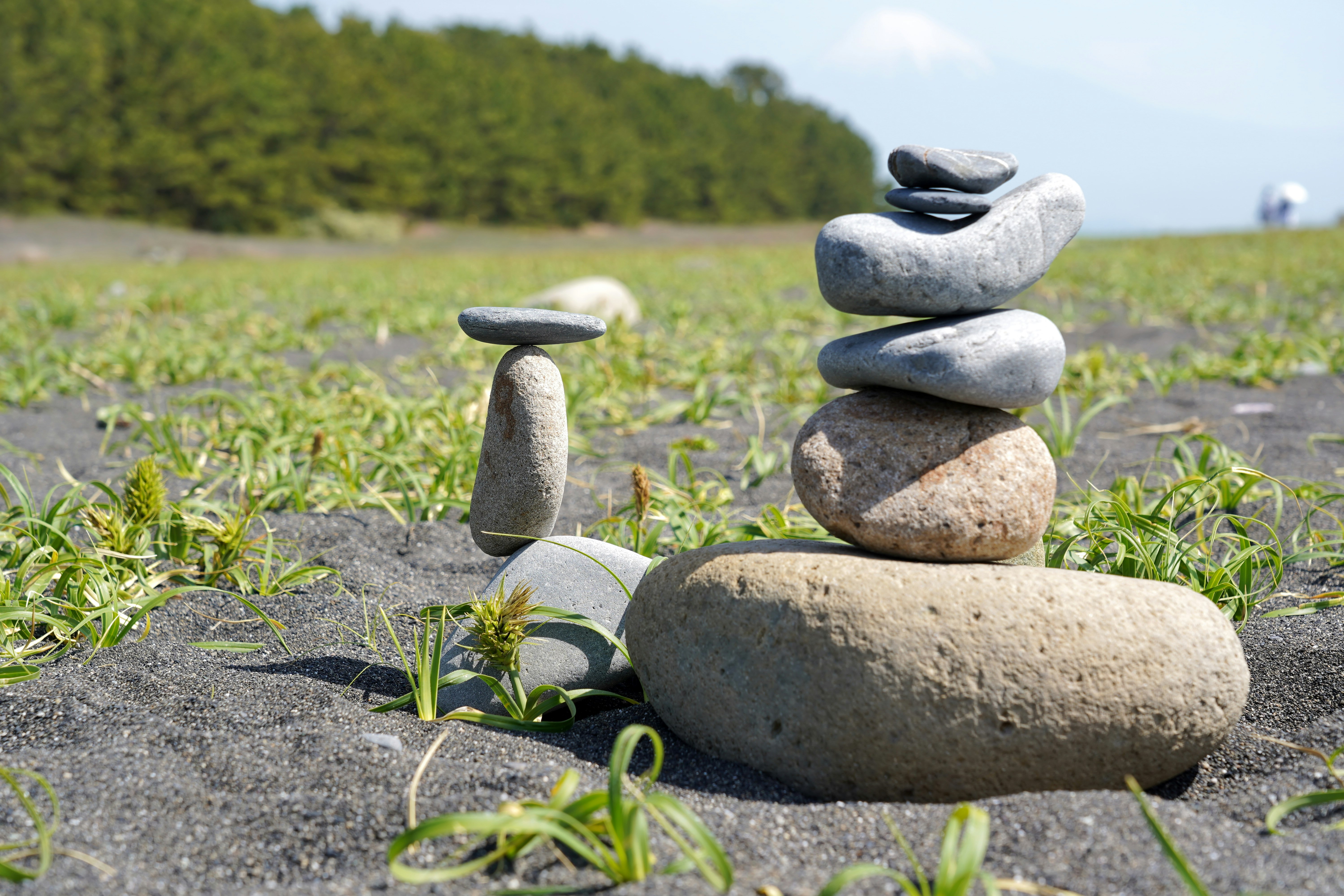 stone balancing stack on a path with grass