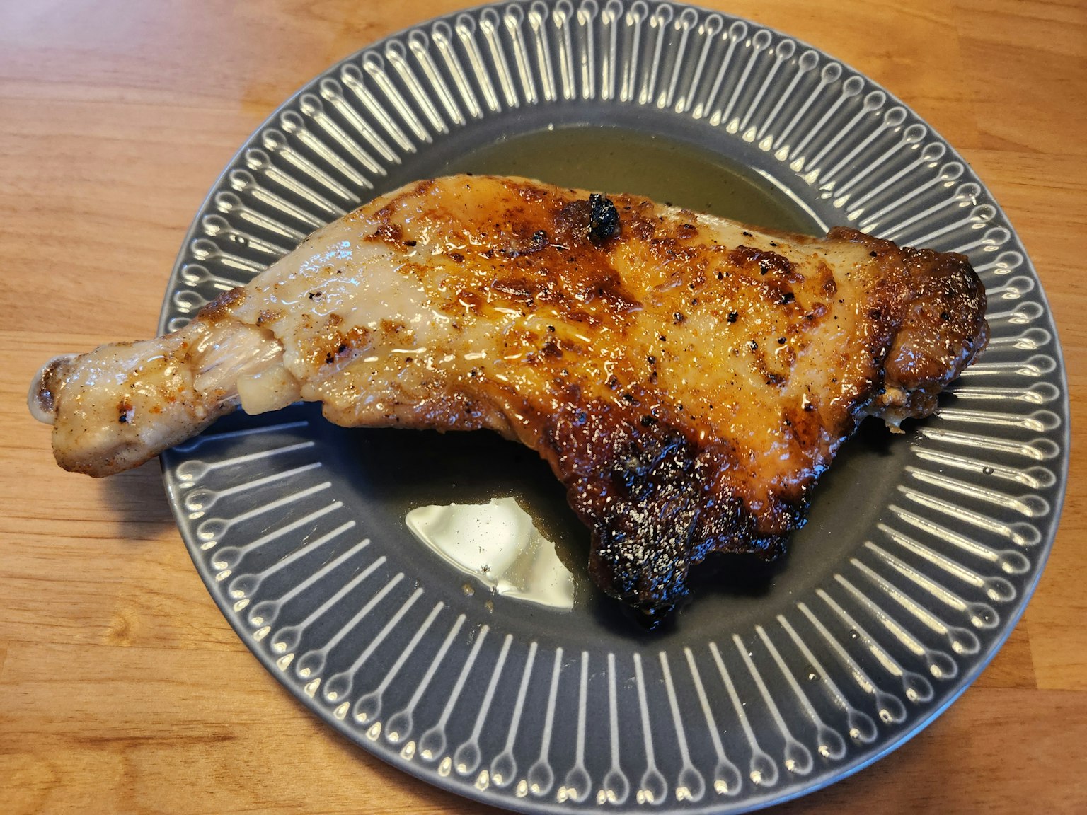 Grilled chicken leg on a decorative plate