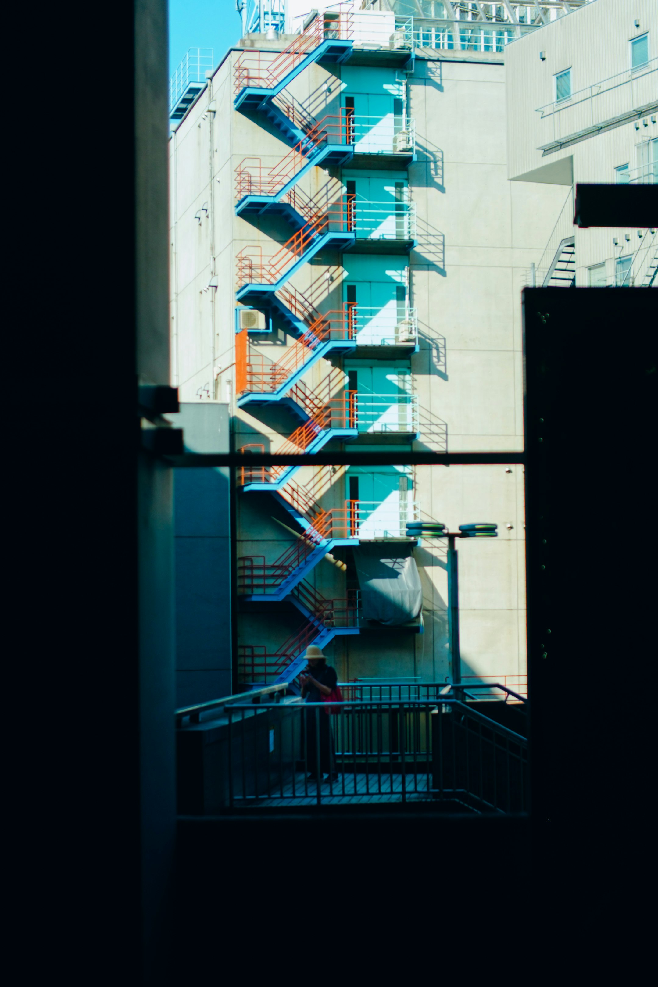 building exterior view with an outdoor staircase and blue railings