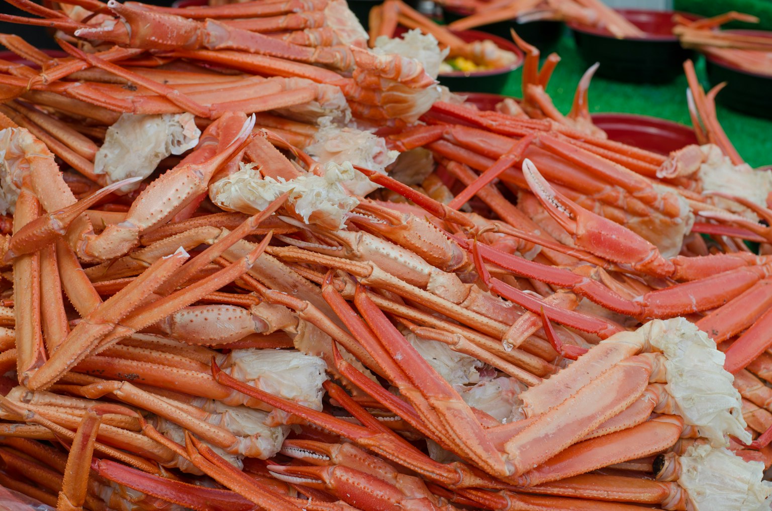 A vibrant display of crab shells and meat piled together in bright orange