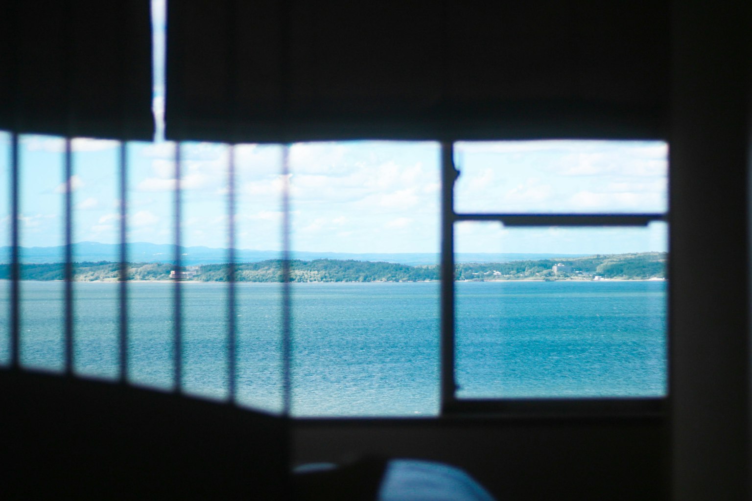 View of the sea and blue sky through a window