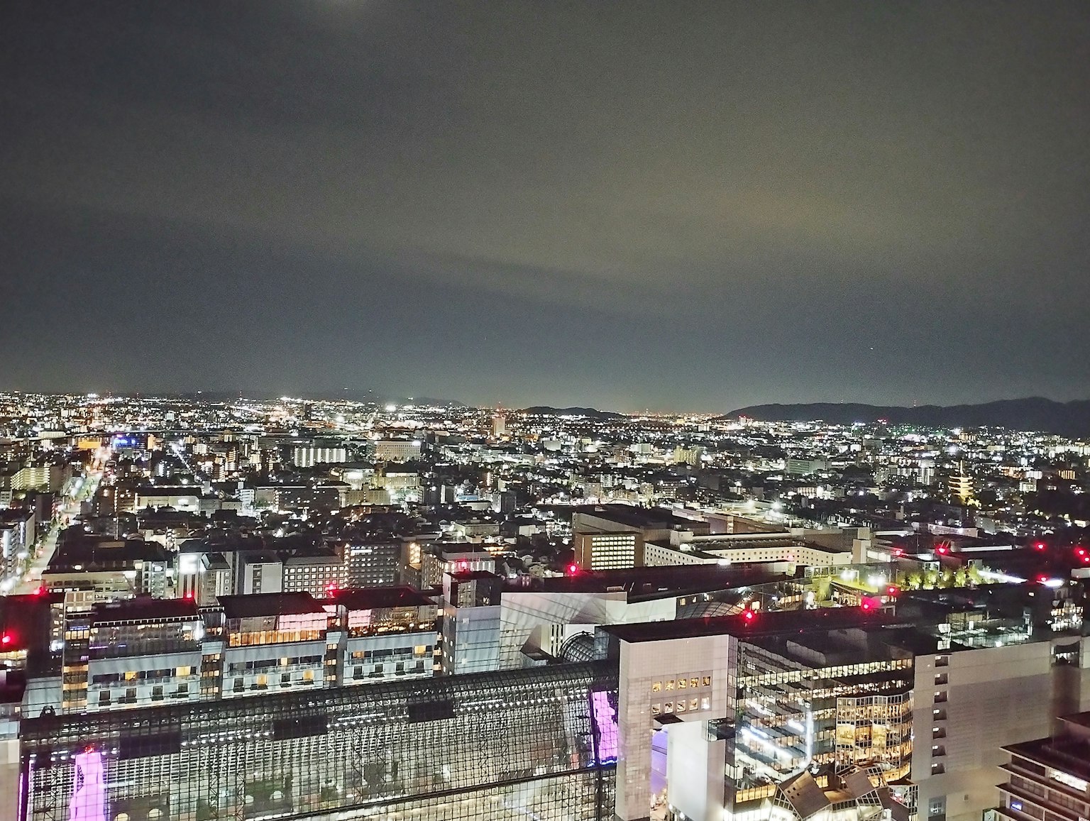 Night cityscape featuring high-rise buildings and city lights
