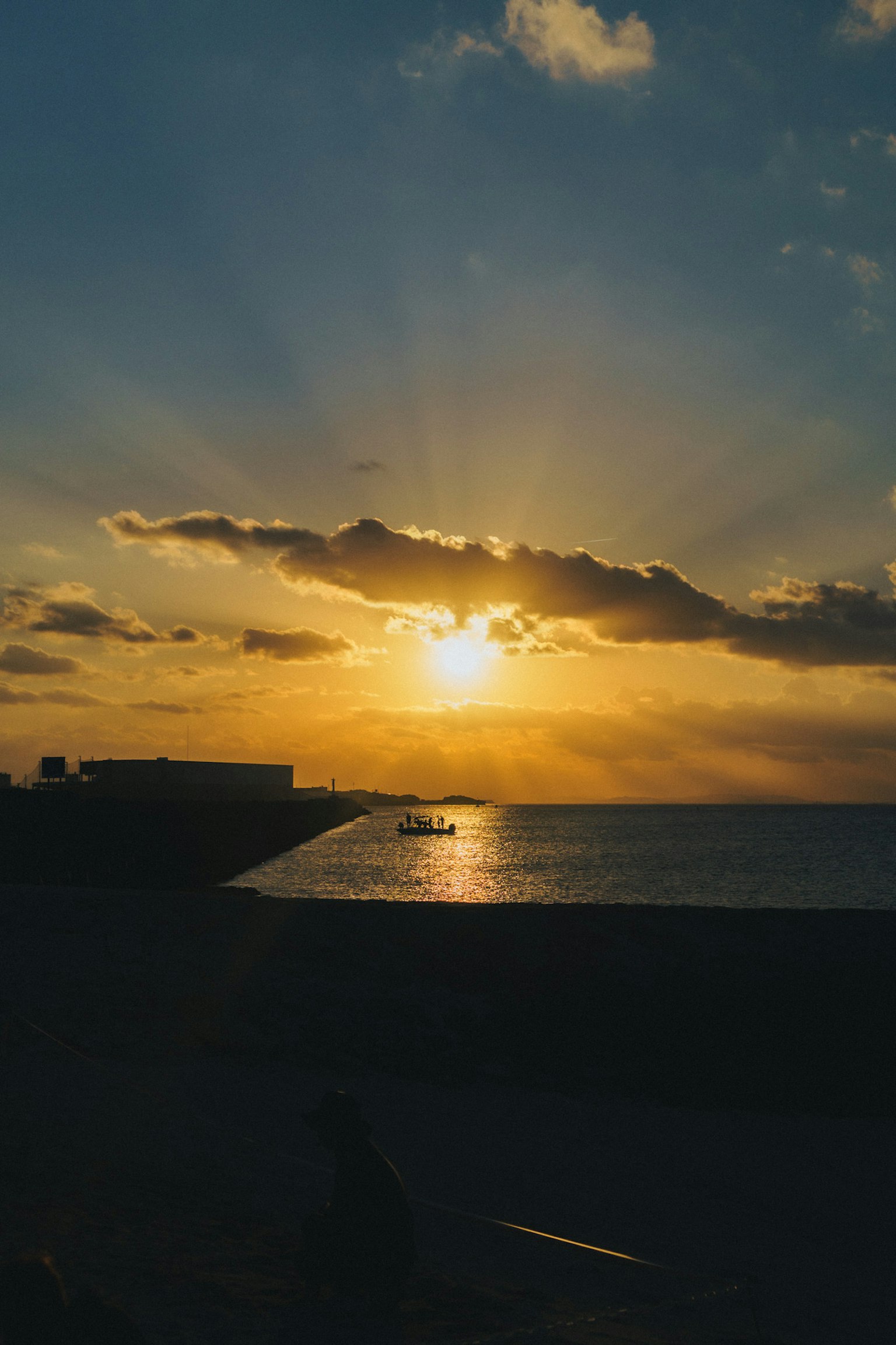 Beautiful sunset over the ocean with rays of light breaking through the clouds