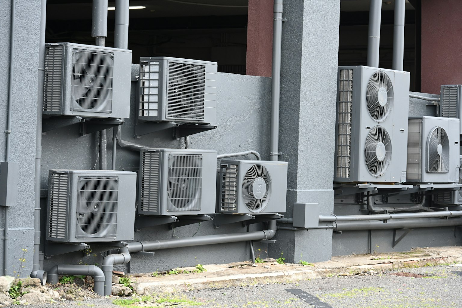 Multiple air conditioning units mounted on a building's exterior wall