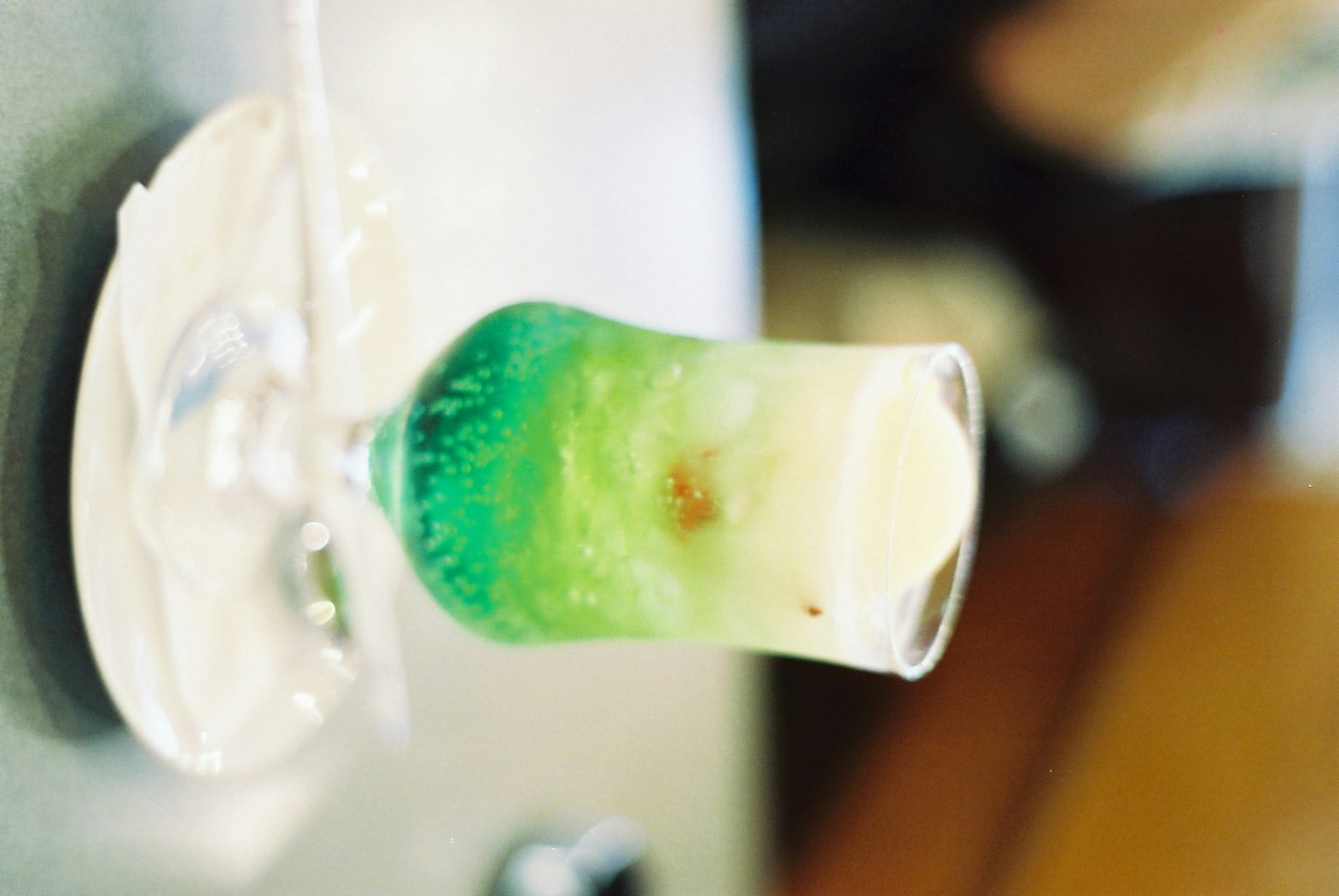 Un cocktail avec de belles couches vertes et blanches dans un verre