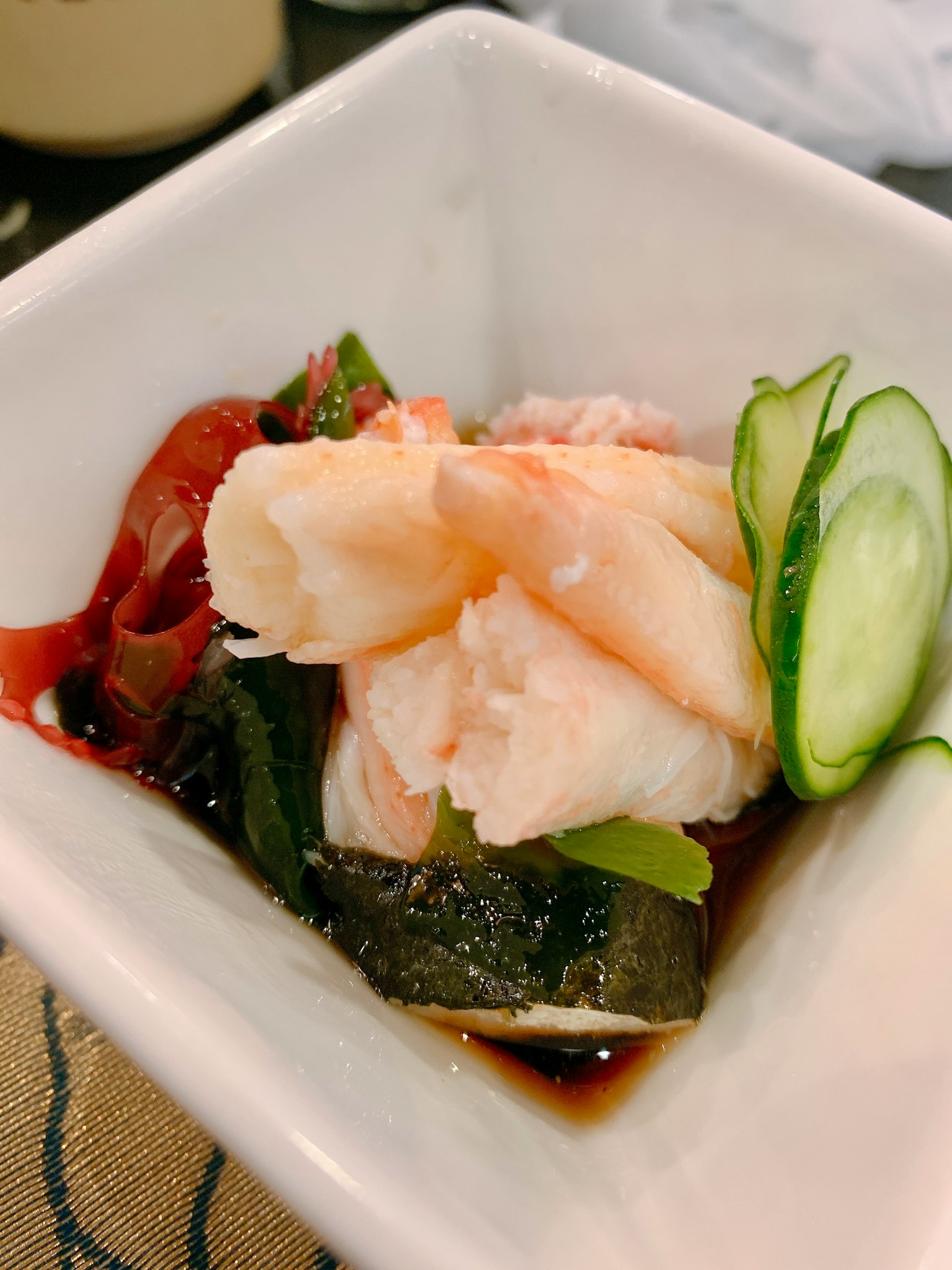 Sashimi ikan putih dengan sayuran disajikan dalam mangkuk kecil dengan kecap