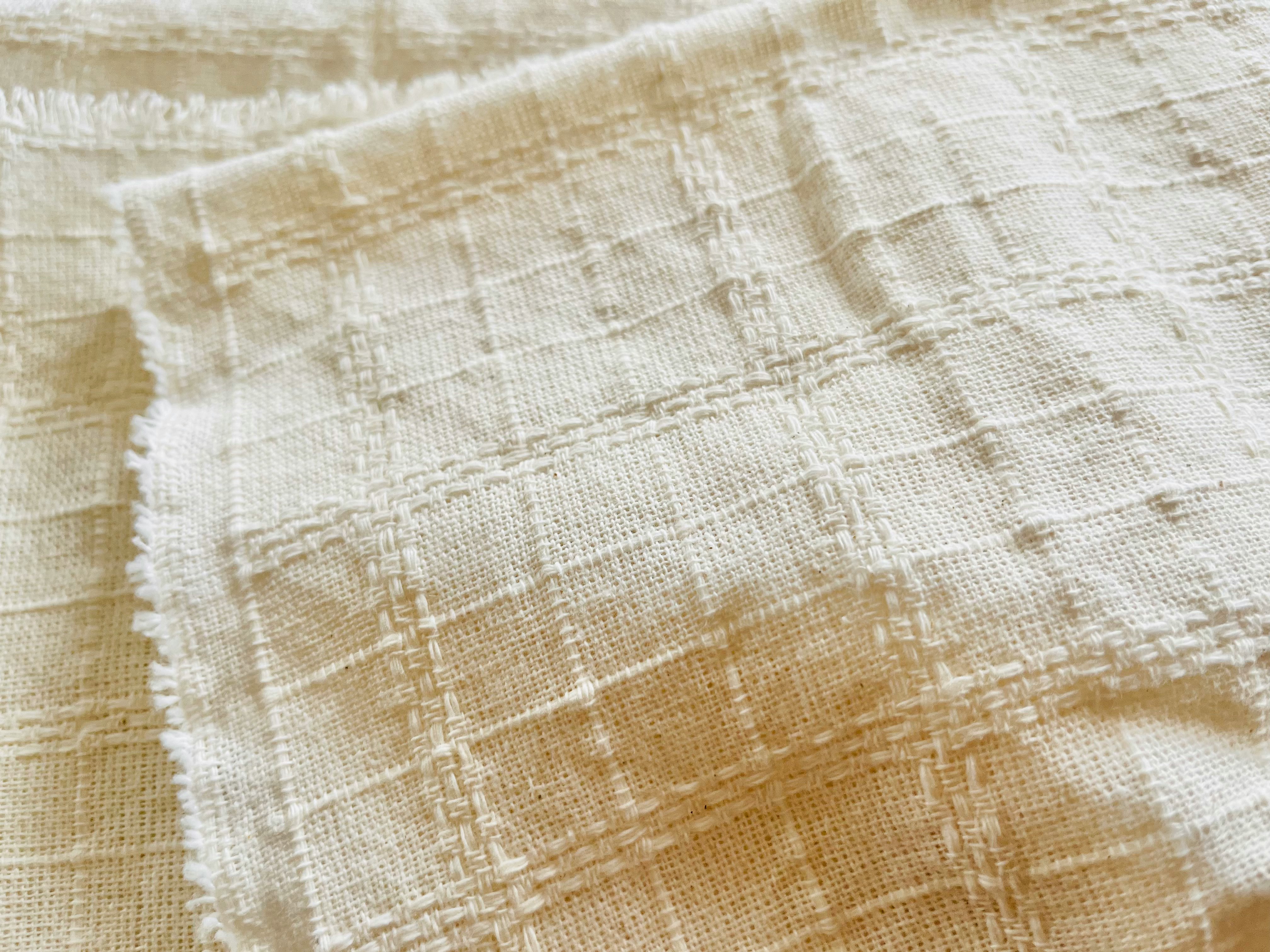 off-white woven fabric texture with visible threads