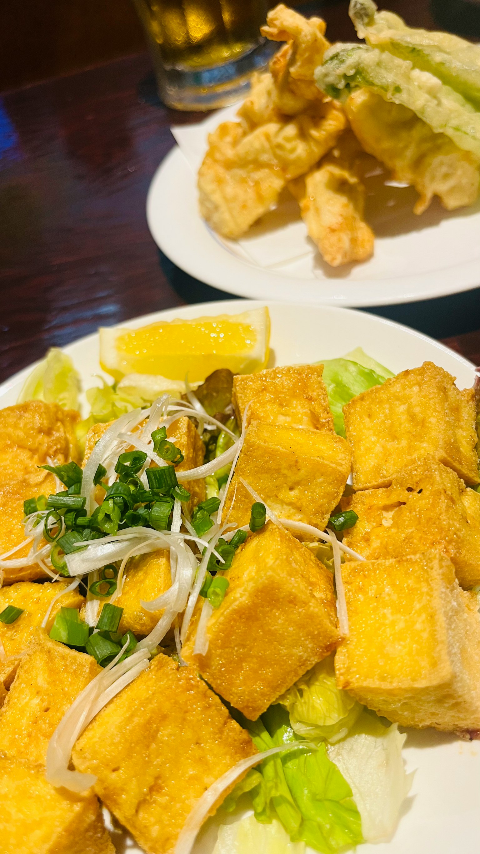 Fried tofu served with lettuce and slices of lemon