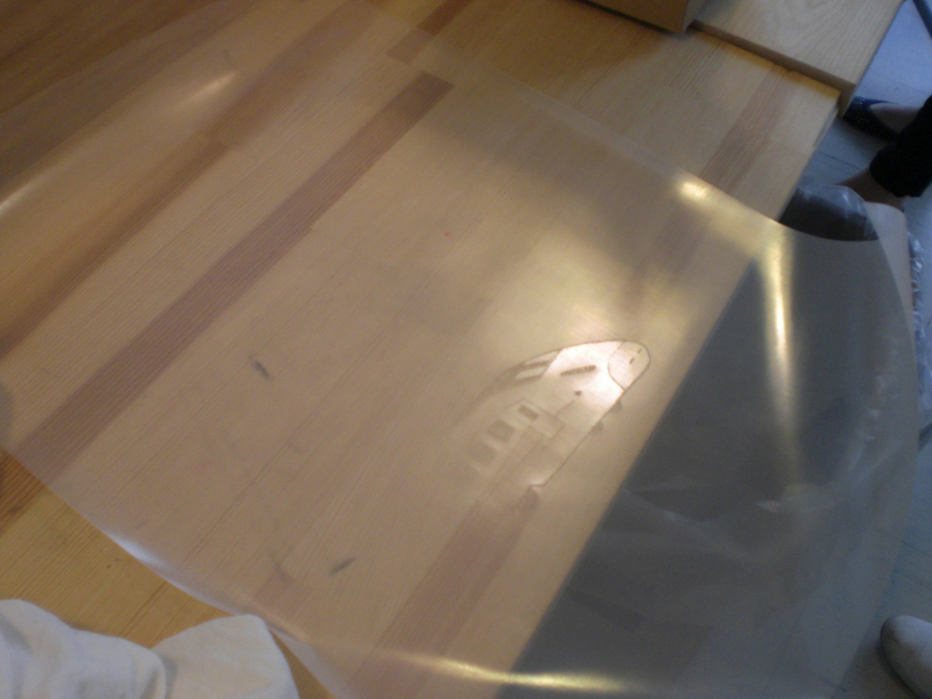 transparent plastic sheet placed on top of a cardboard box