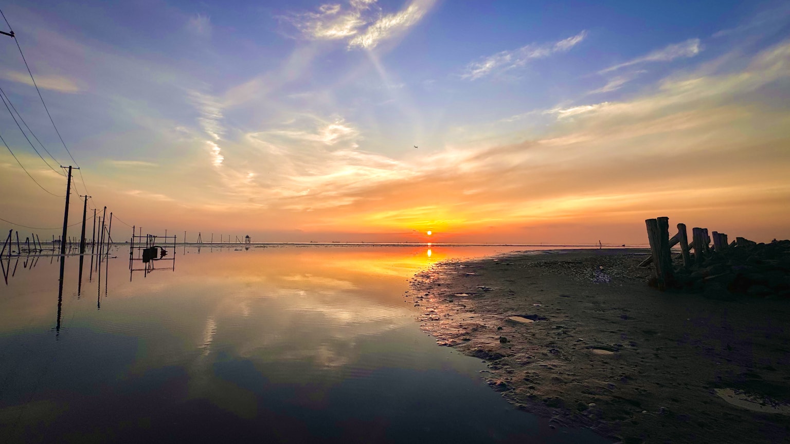 Beautiful landscape with sunset reflecting on water and calm shoreline