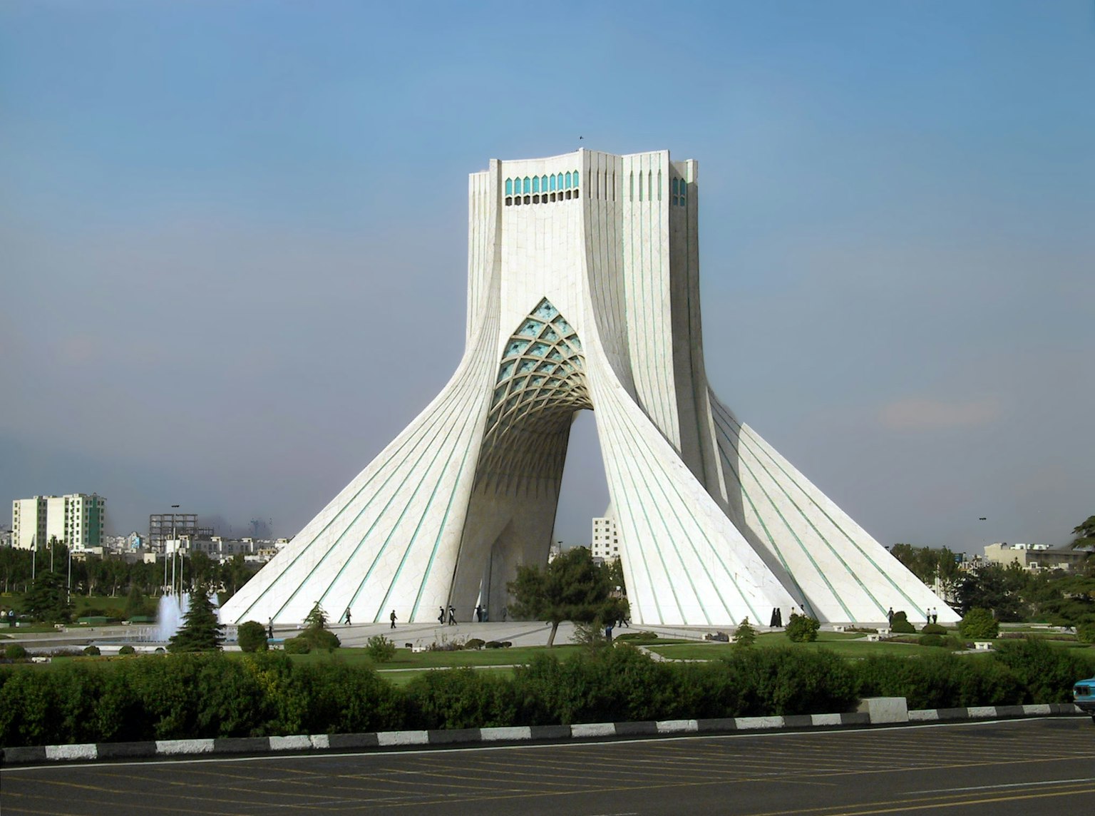 White arch-shaped building against a blue sky