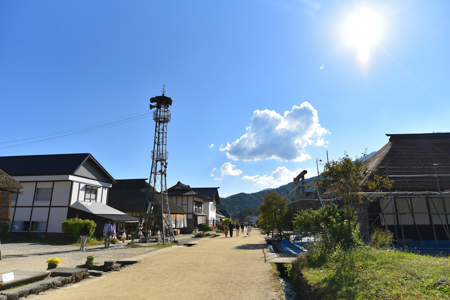 Historic street scene under a blue sky with a communication tower