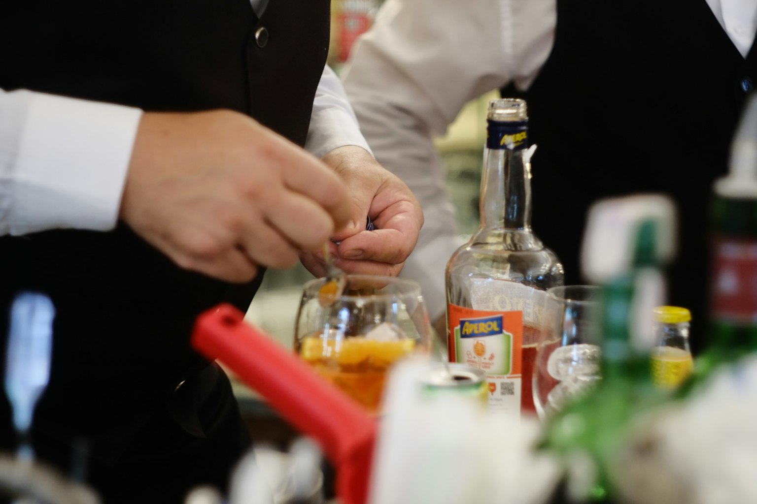 Bartender menyiapkan koktail dengan irisan jeruk terlihat