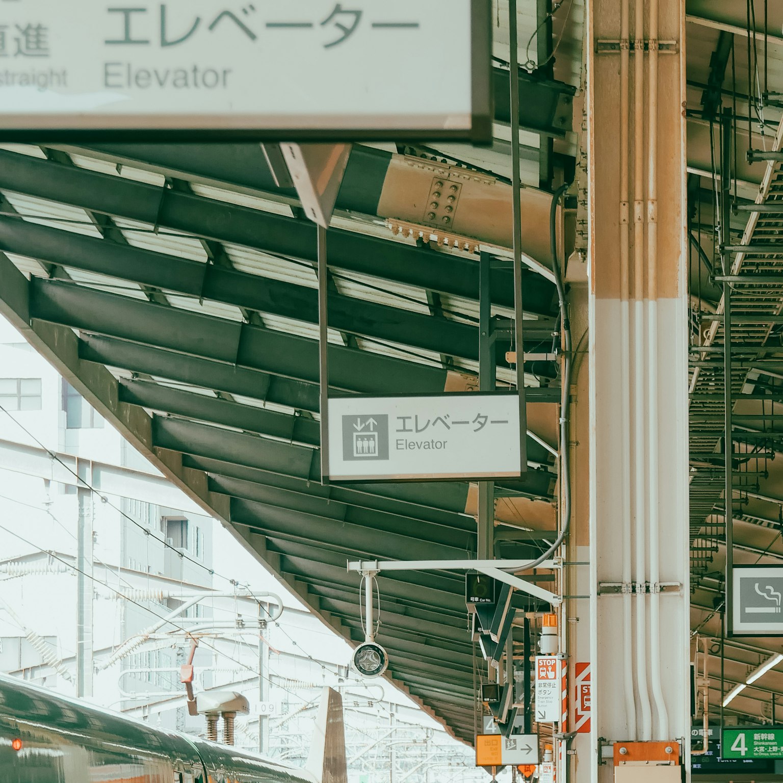 Elevator sign at a train station with modern architecture