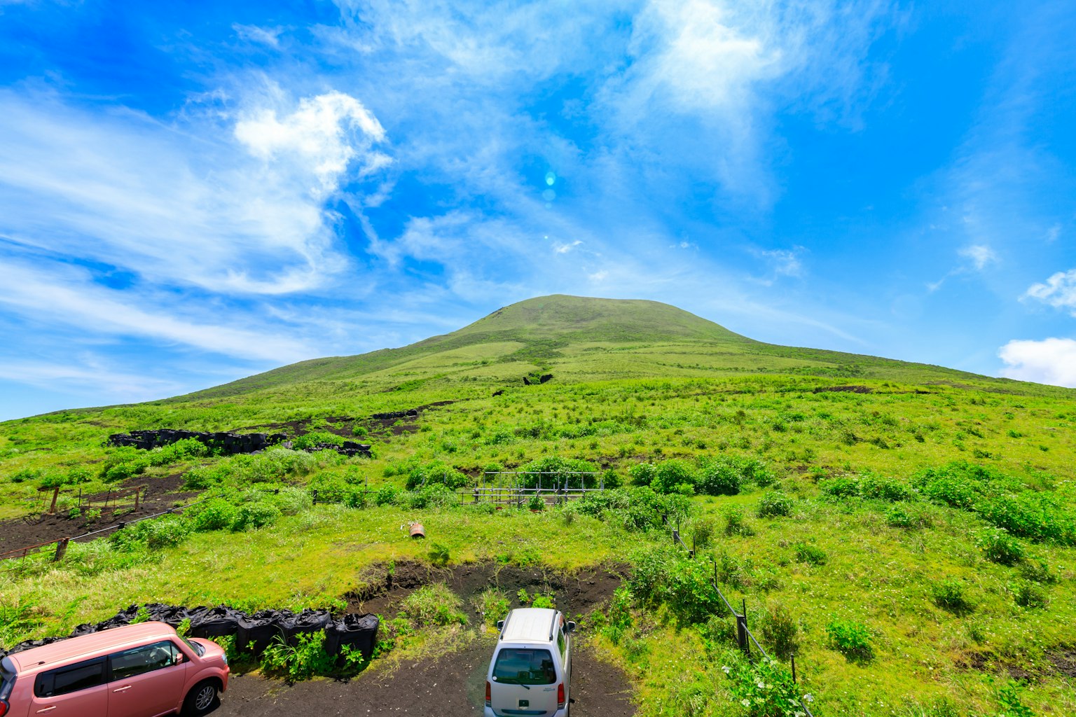 Paesaggio con una collina verde sotto un cielo blu
