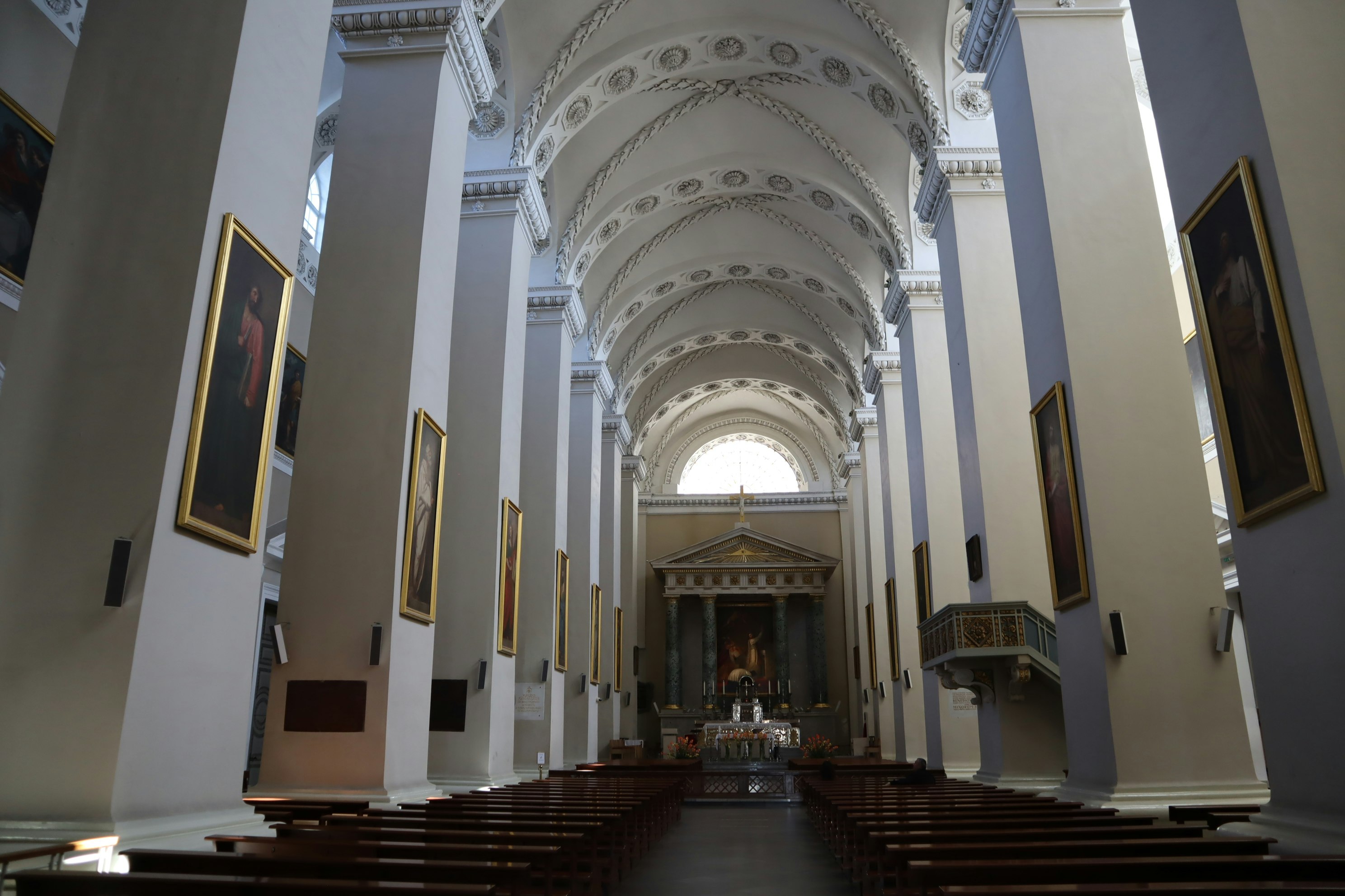 Interior of a church with tall white columns and arches
