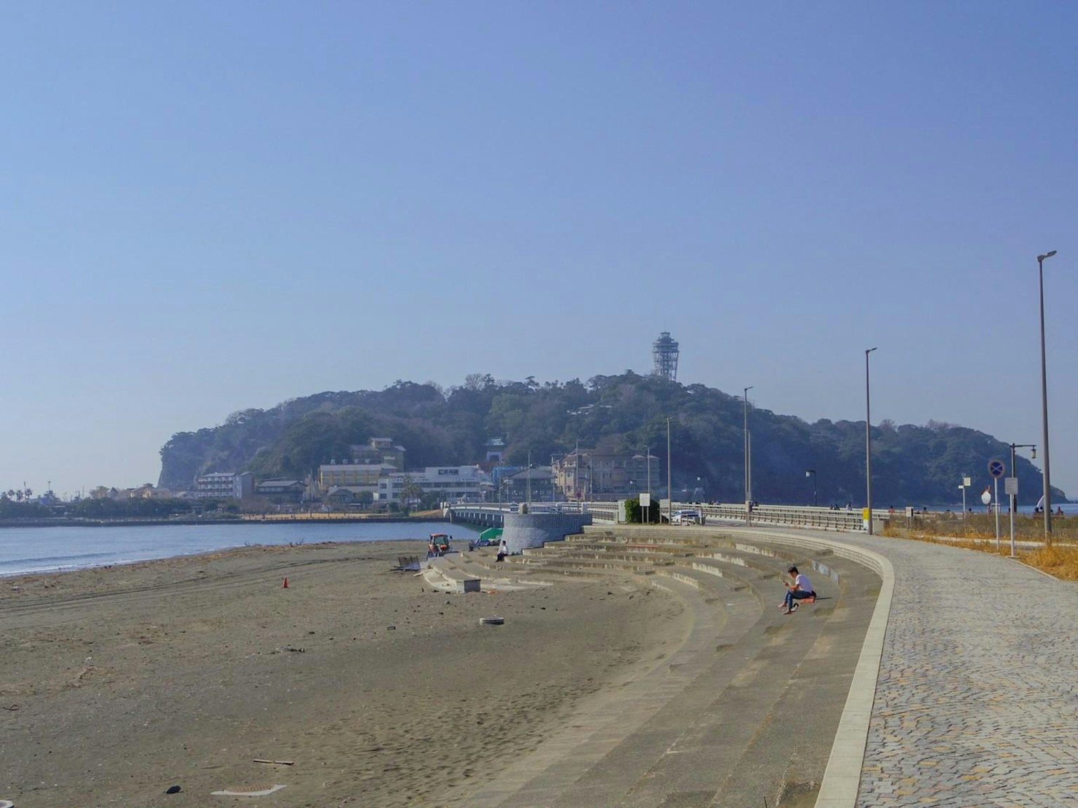 Scenic view of a coastal path with a lighthouse