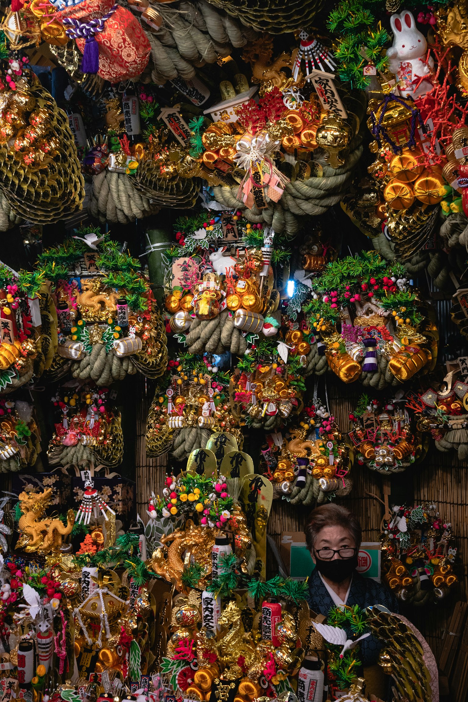 Person surrounded by colorful decorative baskets filled with various ornaments