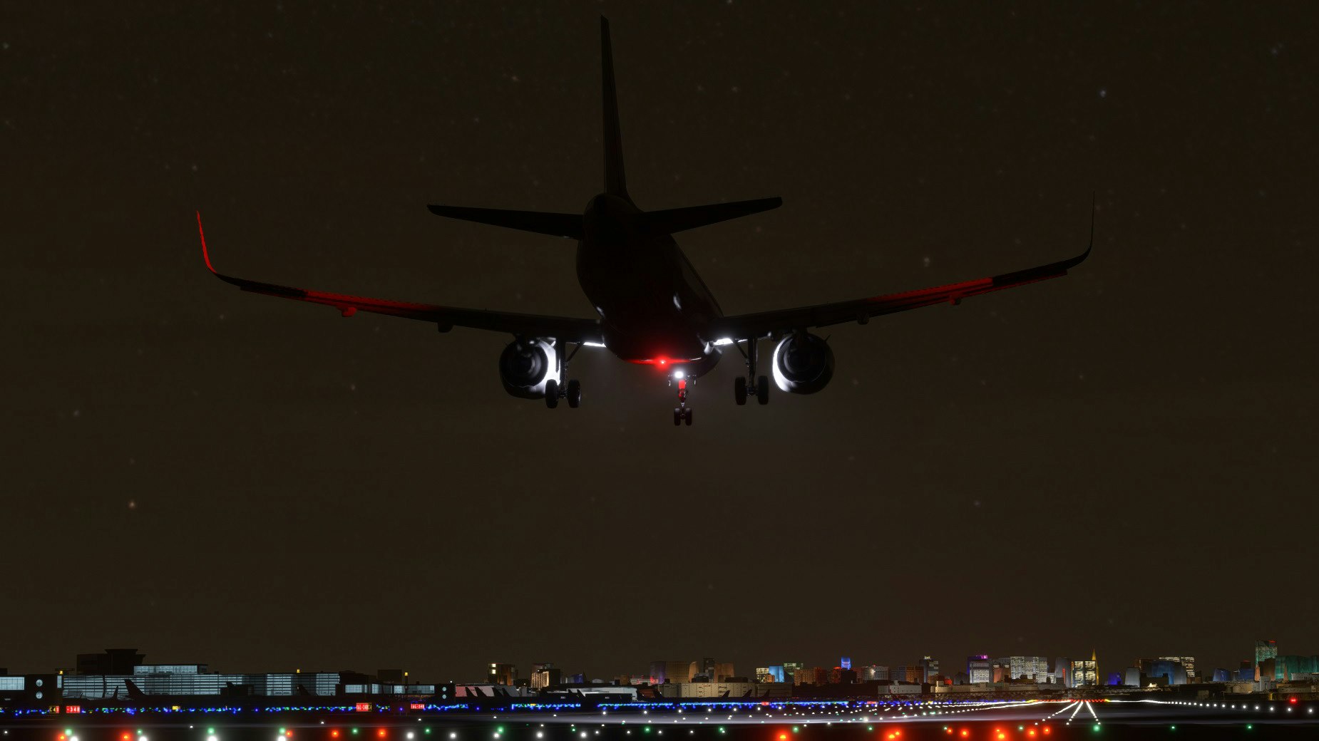 夜間跑道上空中接近的客機正面