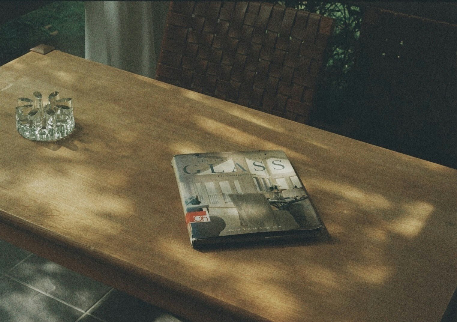 magazine and glass on a wooden table
