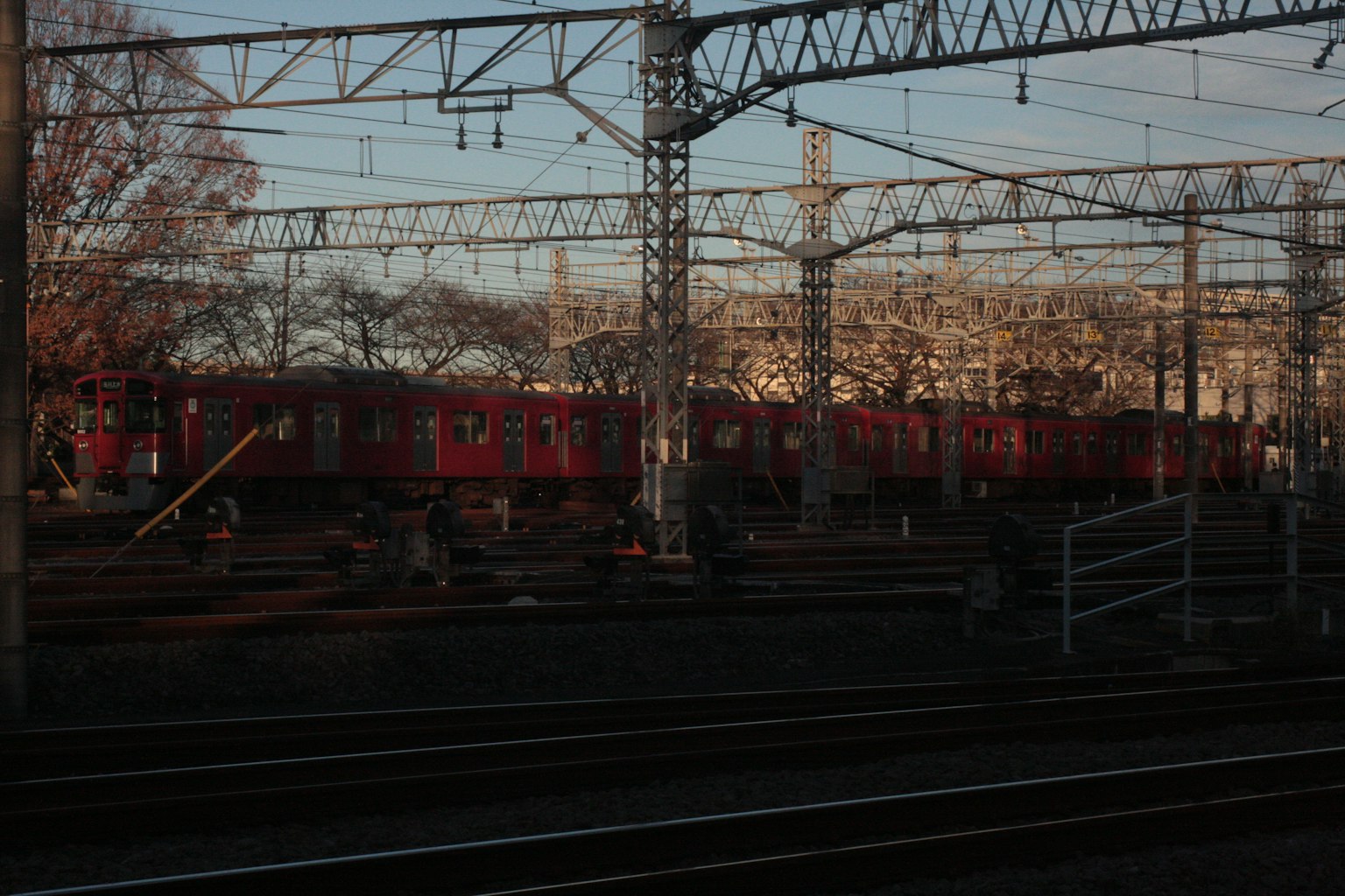 A scene featuring a red train on railway tracks