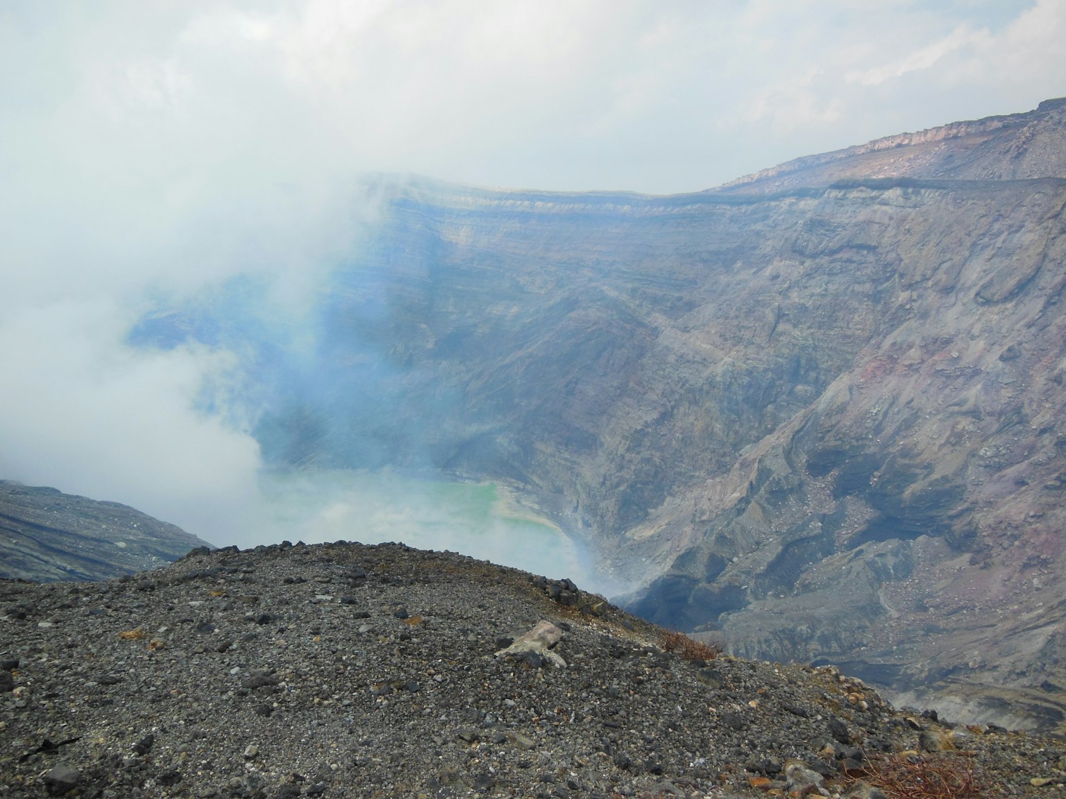 Breathtaking view of a volcanic crater with smoke