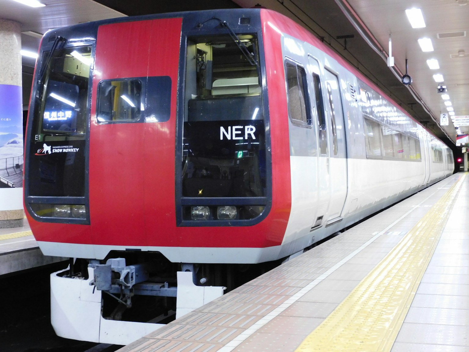 Red and white train stopped at the station