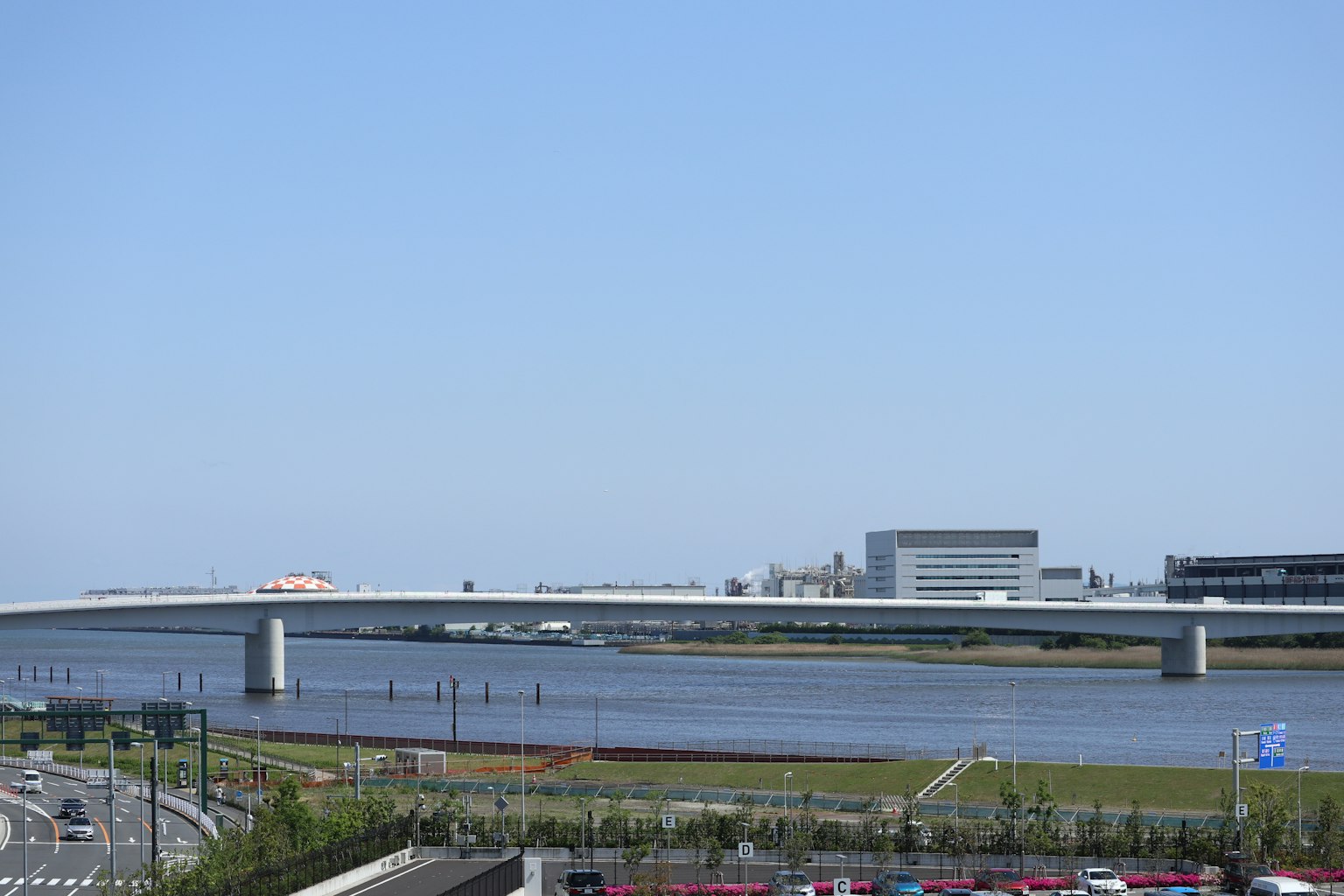 Scenic view of a river and bridge under a clear blue sky