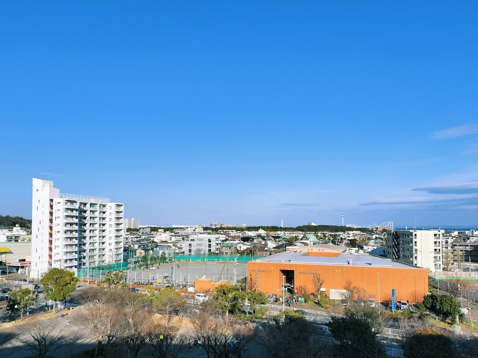 Residential area with an orange building under a clear blue sky