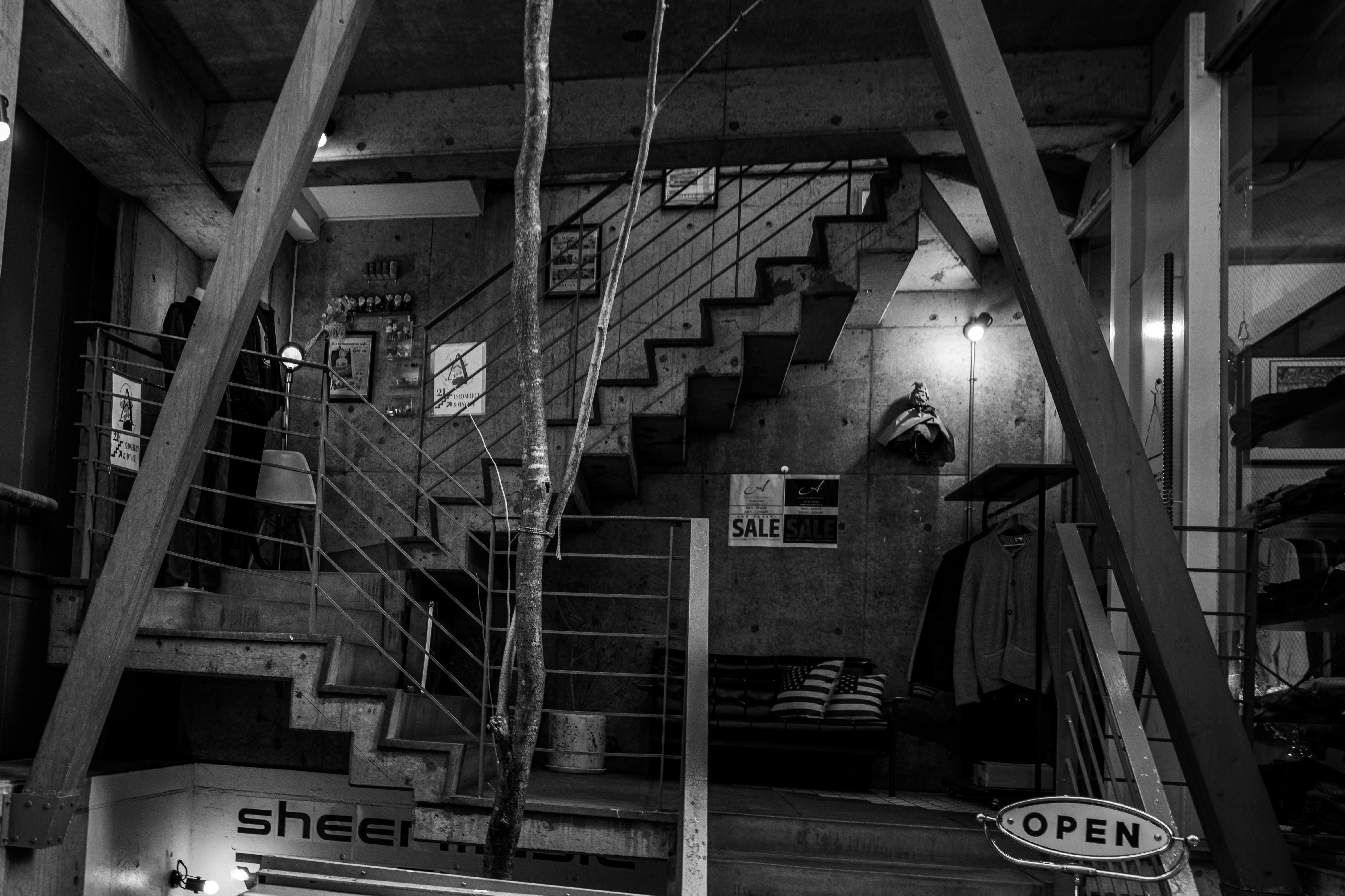 black-and-white street snapshot of a storefront with stairs